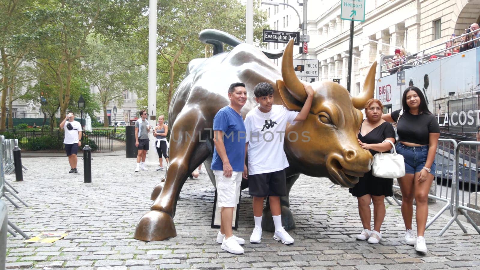 New York City, United States - 9 Sept 2023: Charging Bull, Wall street Stock Exchange symbol in USA. Lower Manhattan Downtown Financial District. American Broadway street. Tourist people photographing