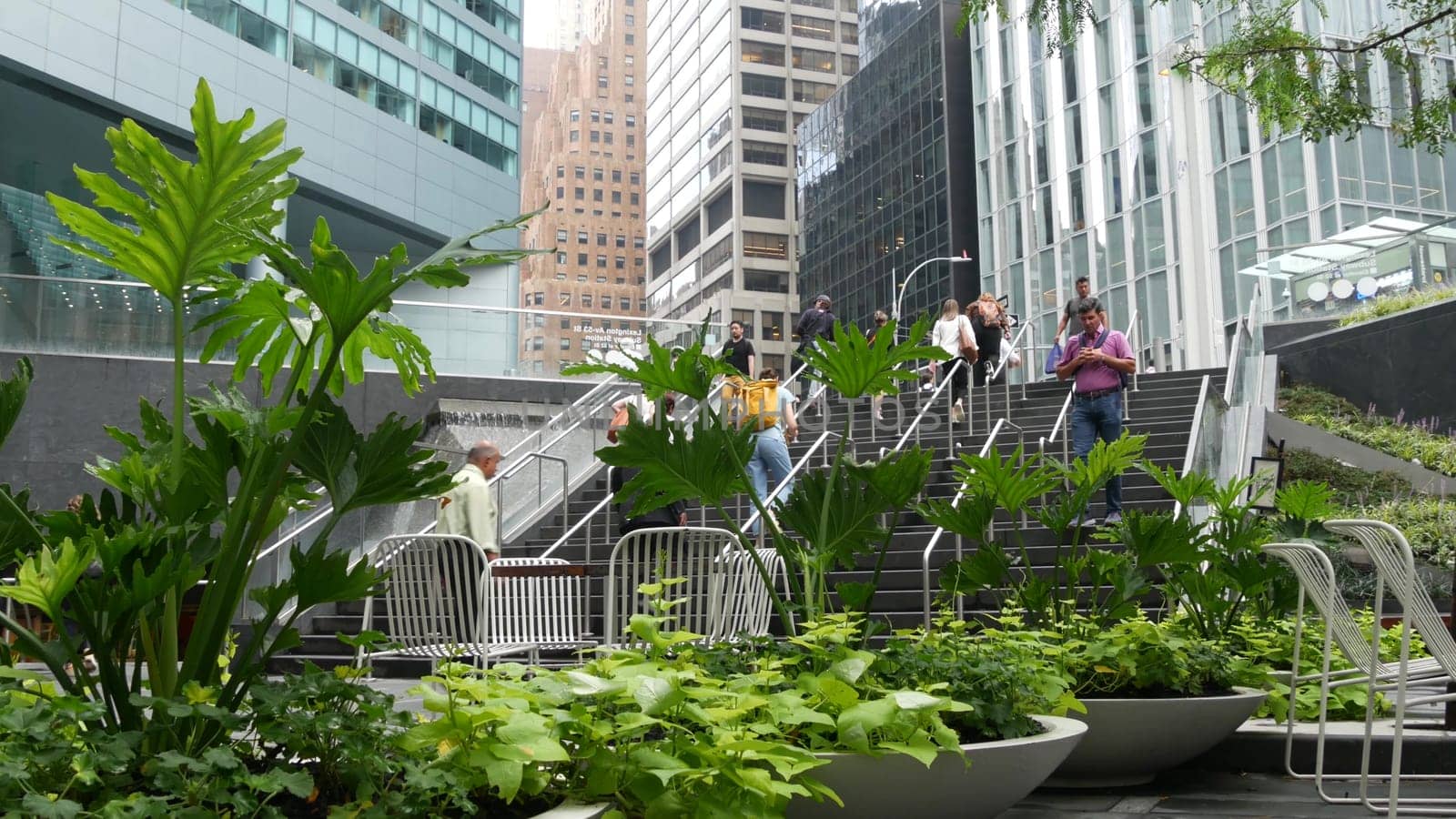 New York City, United States - 11 Sept 2023: Manhattan Midtown office buildings, Lexington avenue, United States. People pedestrian exiting subway metro station, stairs on 53 street, USA urban life.