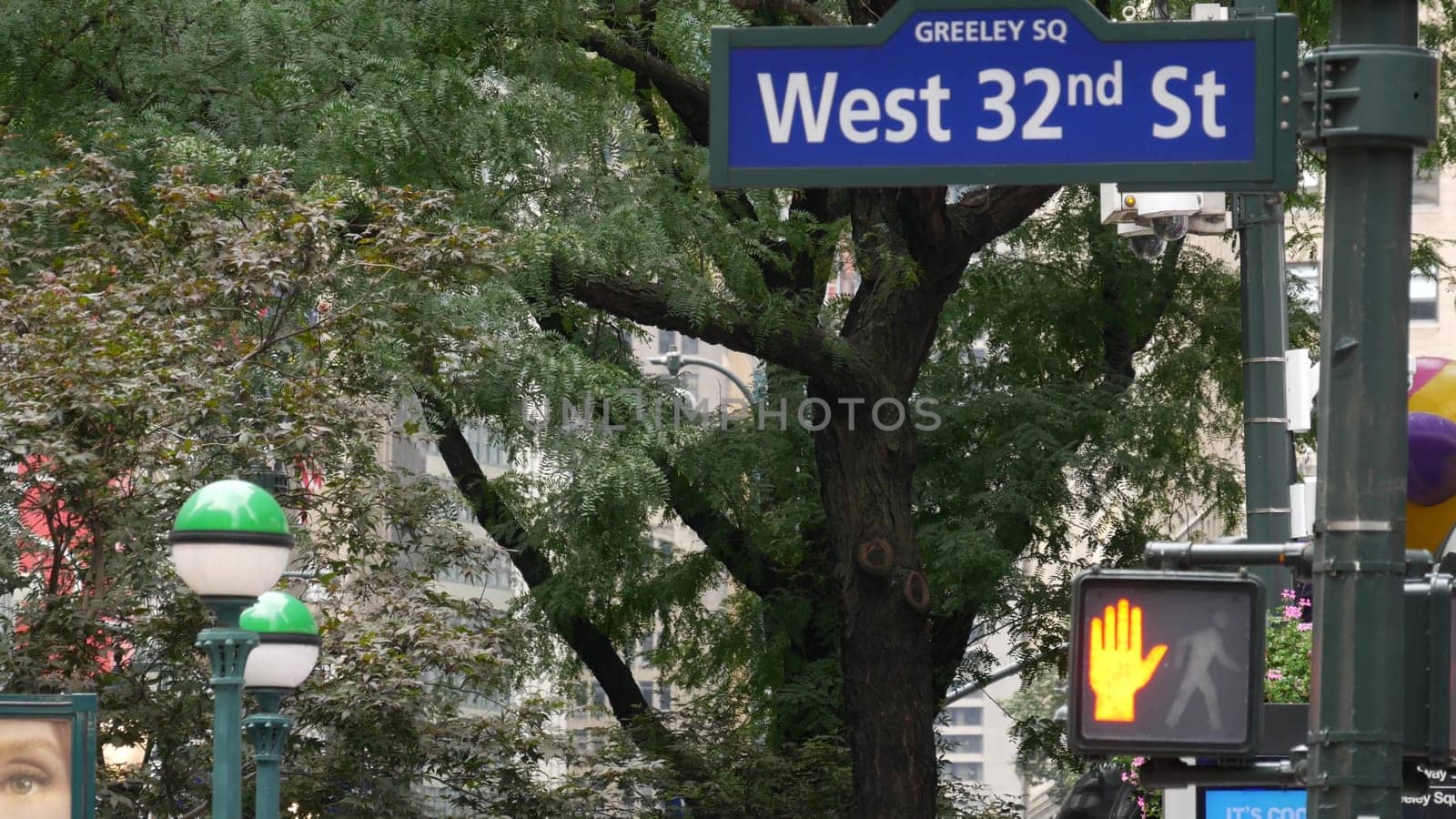 New York City, United States - 29 Aug 2023: Manhattan Broadway street intersection road sign. Midtown district, Greeley, Herald Square. Subway globe, metro entrance orb lamp, traffic light, roadsign.