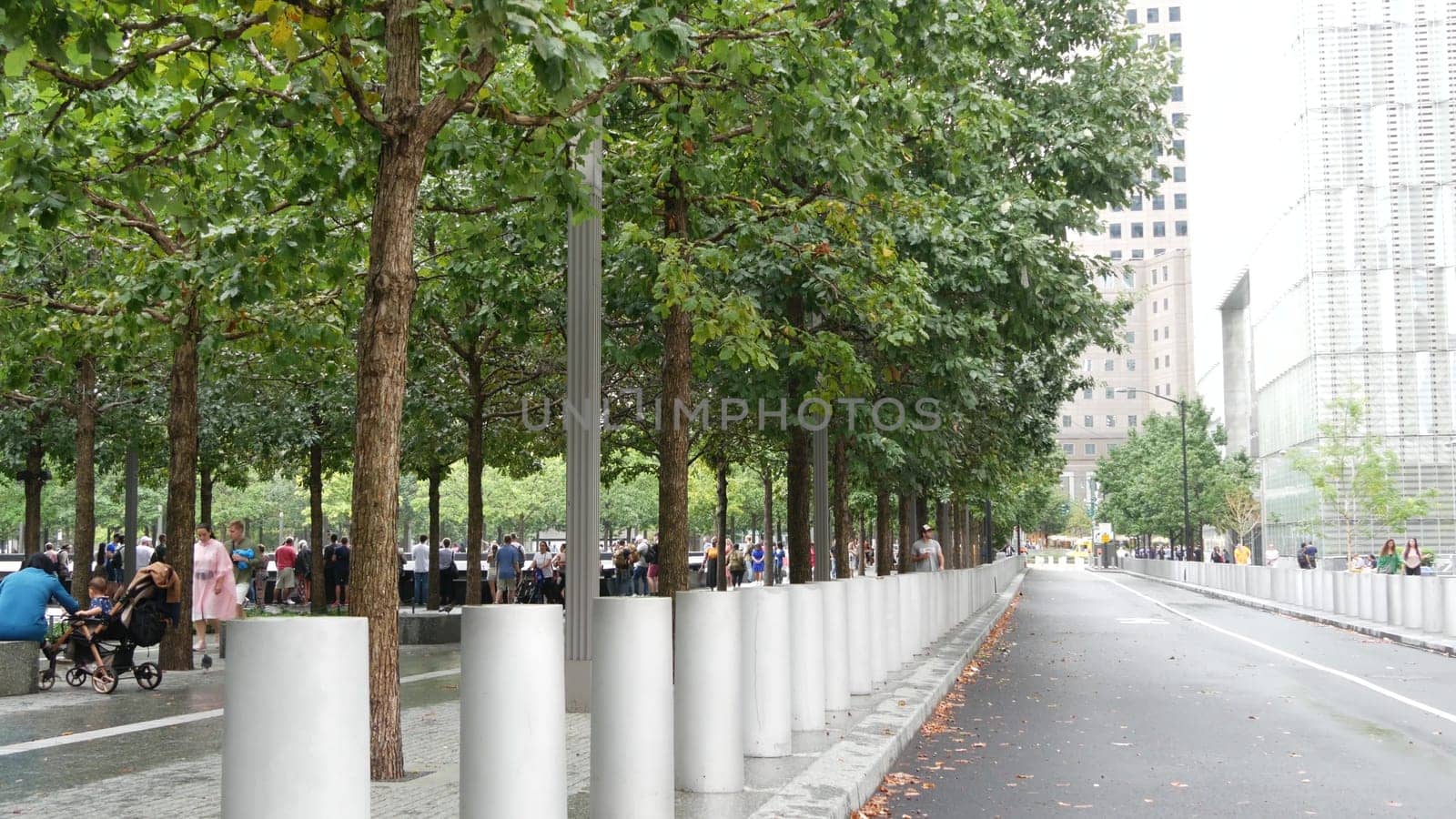 New York City, United States - 10 Sept 2023: Manhattan Downtown Financial District. People near World Trade Center Oculus. Memorial pools and 911 Museum area, Fulton street architecture in USA. Trees.