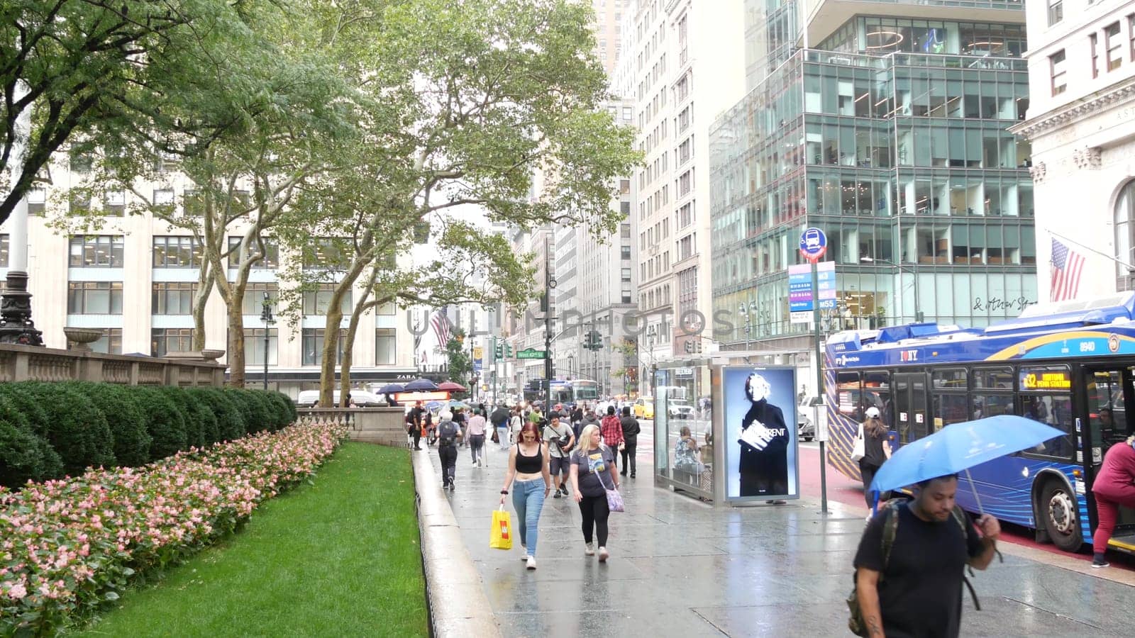 New York City, United States - 13 Sept 2023: Manhattan Midtown, Fifth 5 avenue. 42 street intersection corner near Bryant Park and Library, USA. American urban traffic, people pedestrian on rainy day.