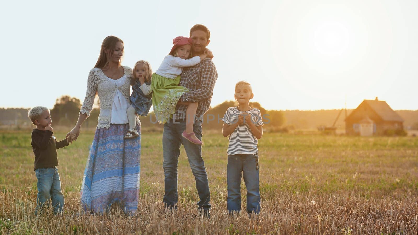 Large family on a background of evening sunset