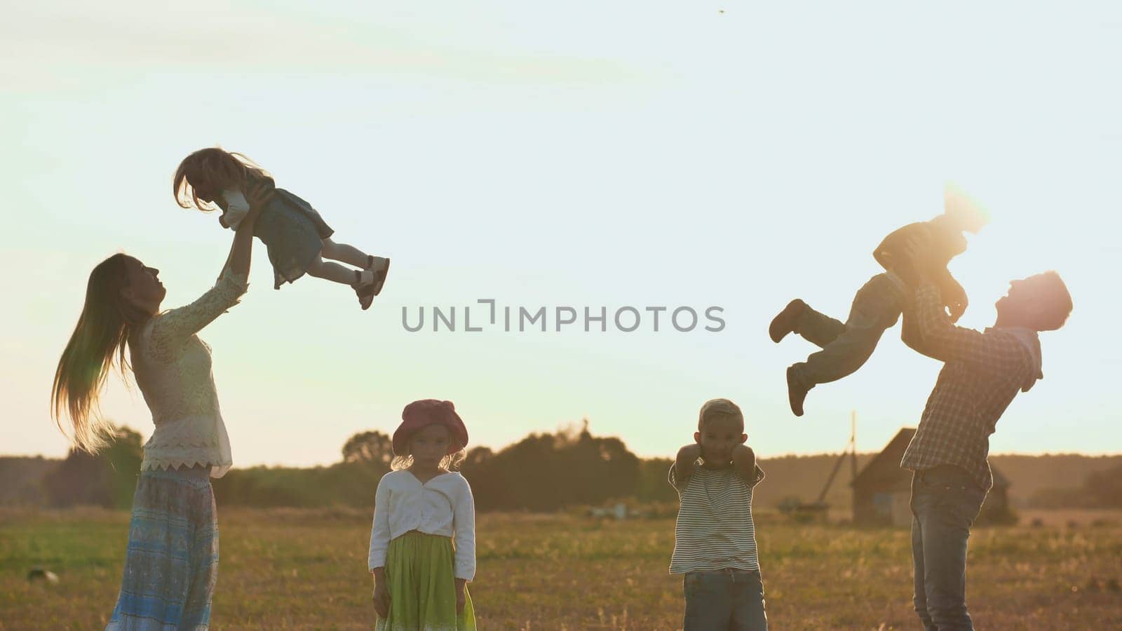 Happy parents of 4 children toss up their children