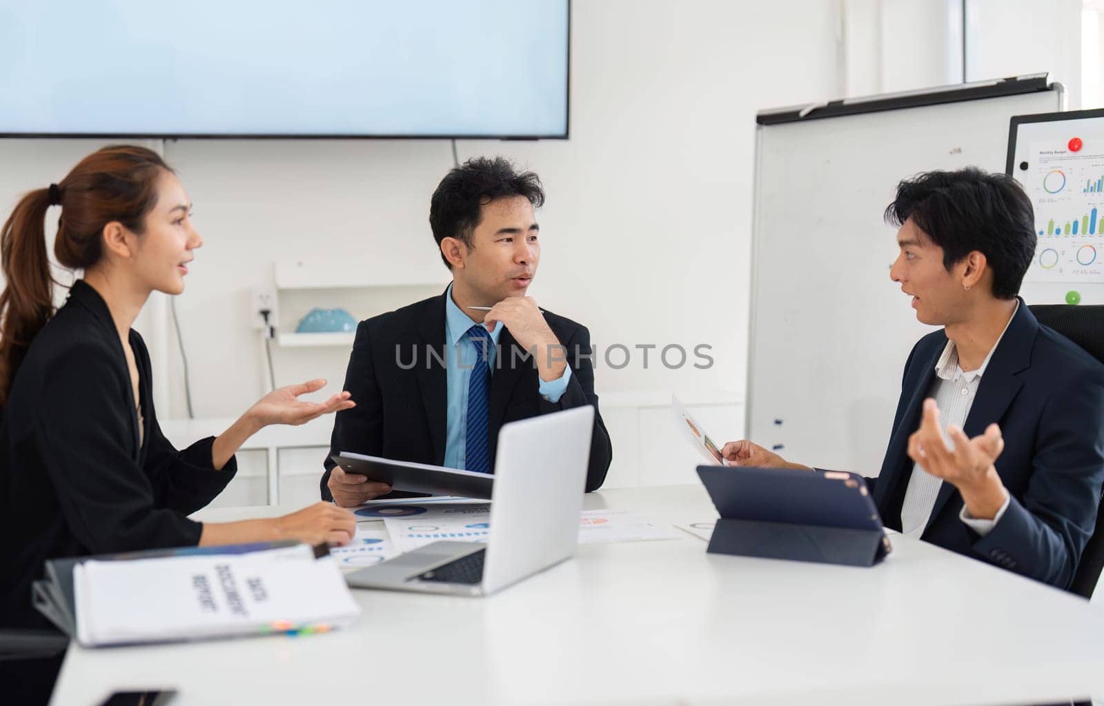 A lively discussion among team members as they utilize digital tools to enhance strategy development, supporting a culture of innovation.