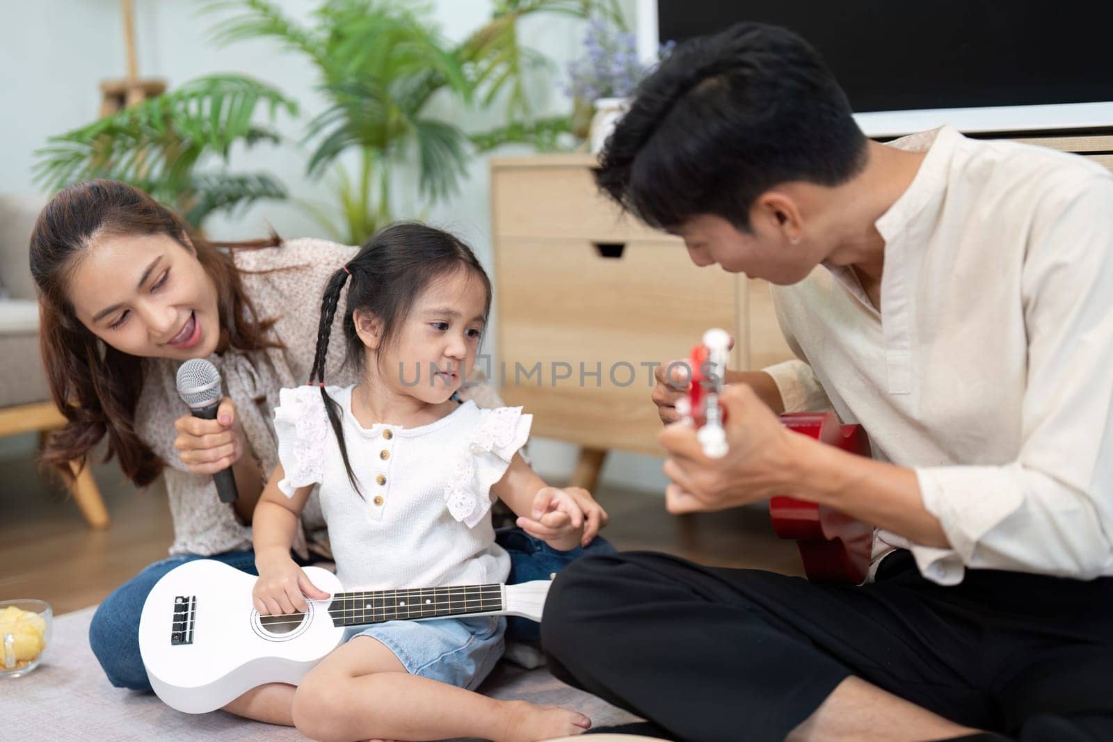 A heartfelt moment as parents support their daughter in playing music, creating a joyful and enriching environment filled with love.