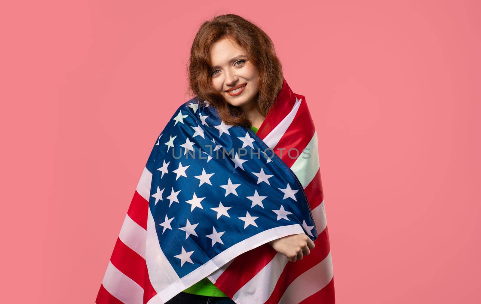 Smiling woman with national USA flag on pink background. American patriot, 4th of July - Independence day celebration, election, America, labor. US banner. High quality