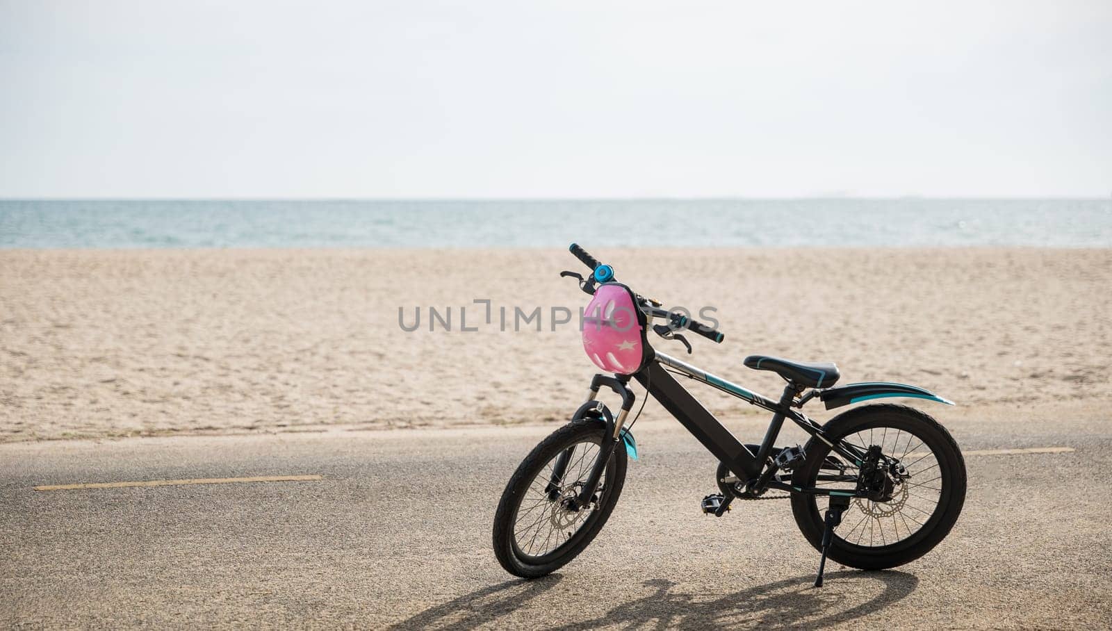 Abstract beauty meets coastal joy, A child's bicycle on the beach symbolizing freedom and relaxation on summer day creating a unique tourism experience by the water waves. bike in summertime vacations