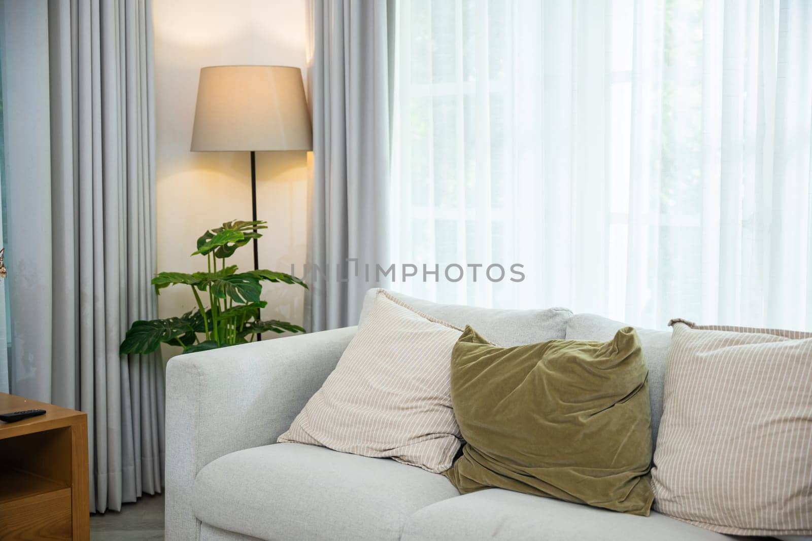 Empty modern living room with a sleek white couch and stylish coffee table, Interior your lifestyle with this versatile modular sectional sofa and the windows have curtains closed, nobody