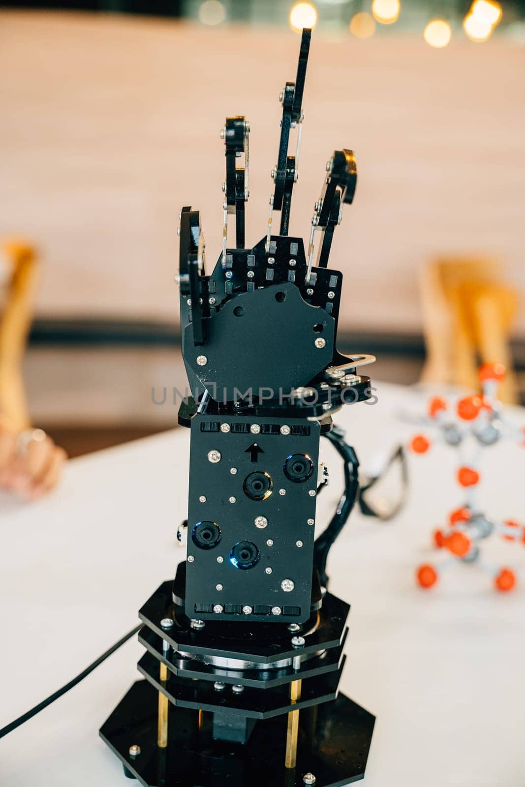 Cyborg mechanical arm in action as a black real robot hand presses on a table. Illustrating futuristic intelligence development and innovative technological evolution.