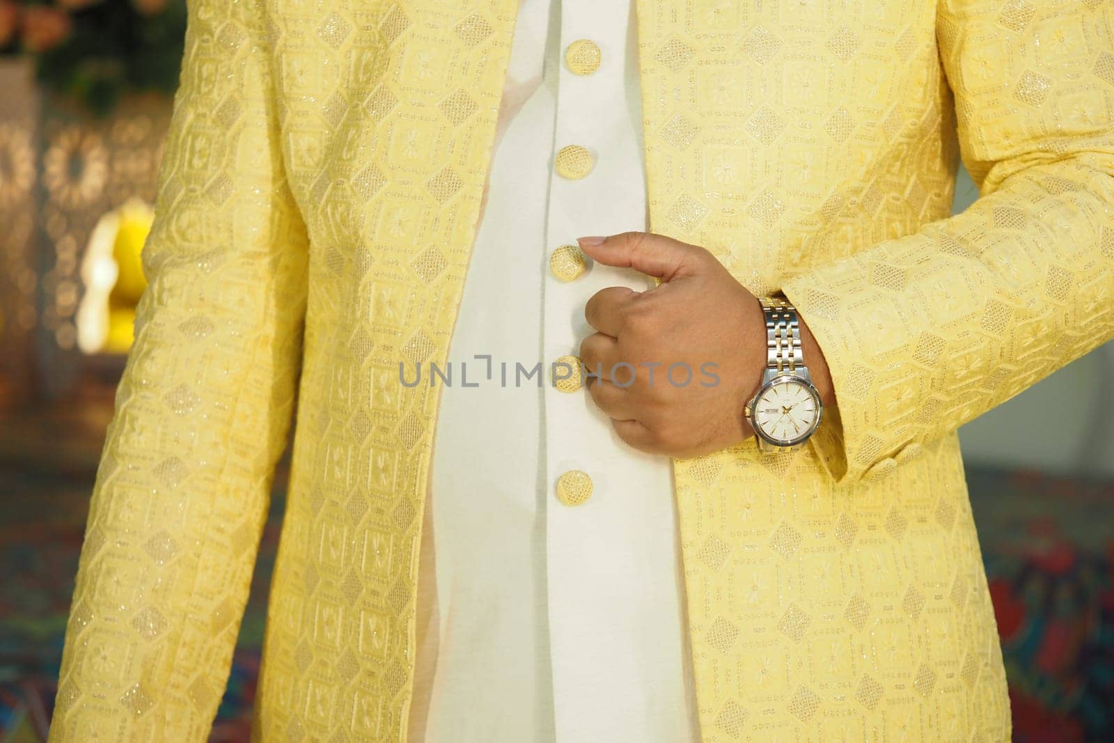 Person in a chic yellow outfit stands confidently with elegance.