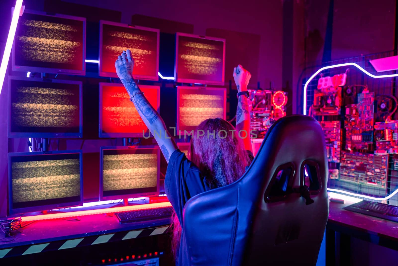 Winning. Happy Gamer young plays online video games computer she raises hands to wins tournament, young woman in gaming headphones playing video game online at home feel excited, E-Sport concept