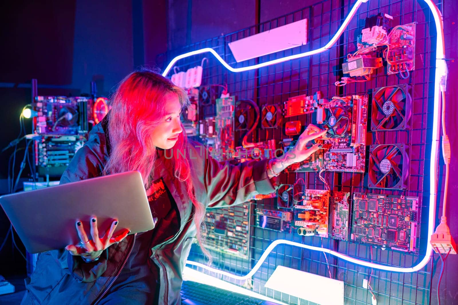 Cyber security. Software engineer holding laptop computer at data center checking hardware, Hacker woman service in server room, check circuit board with many small components