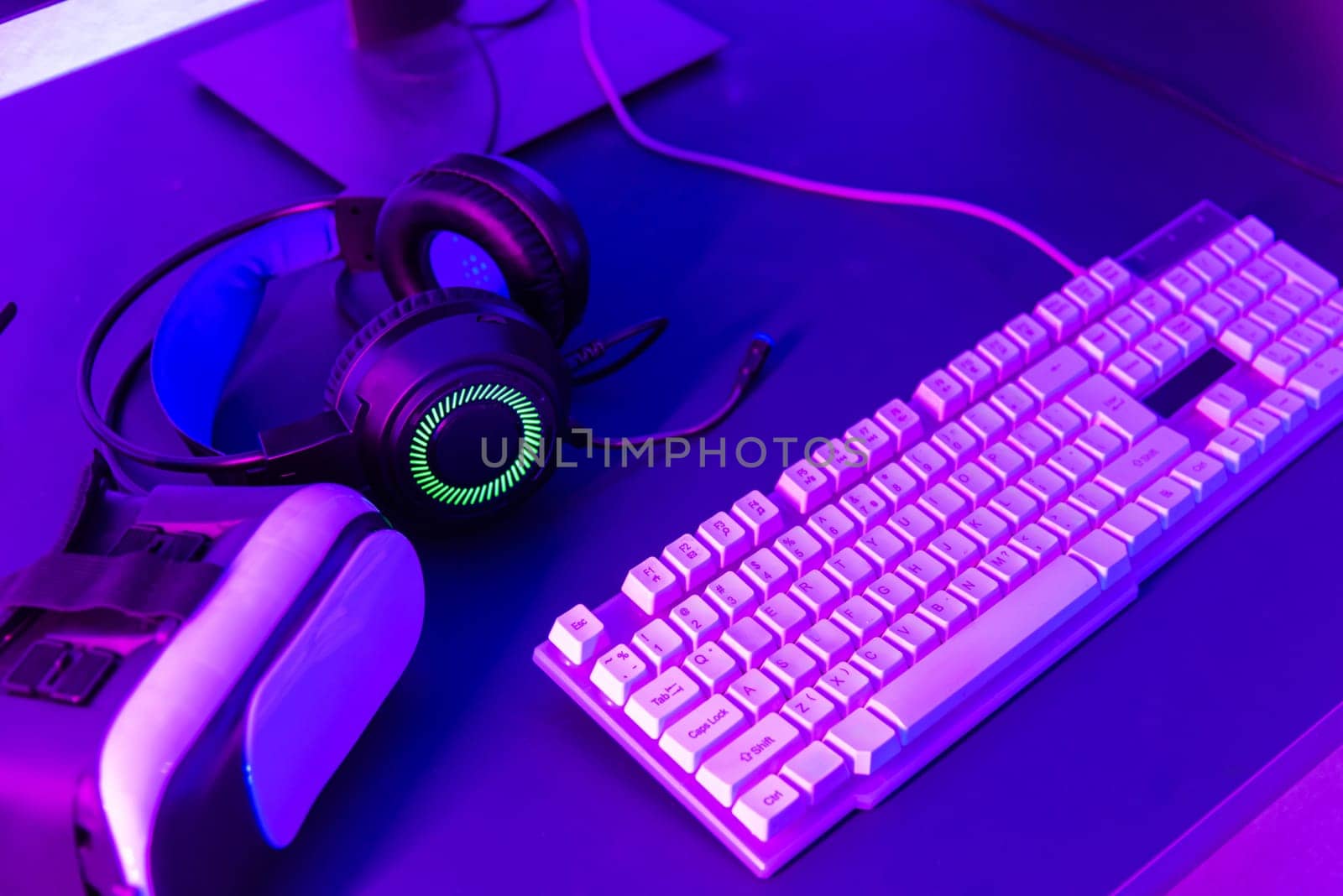 Close up gamer work space gaming set up modern equipment on desk, gaming gear, mouse, headset, computer mouse ready for online streaming