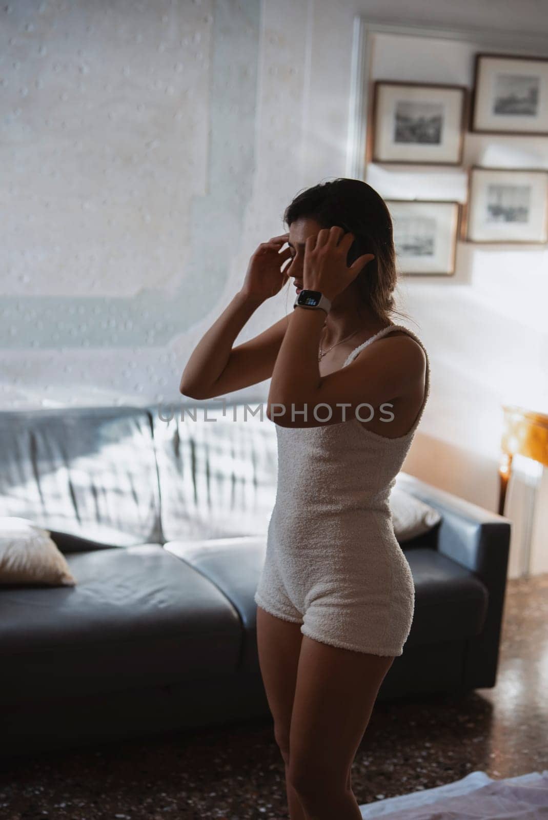 A young woman begins her day with a relaxing morning routine, surrounded by warm light in a cozy setting