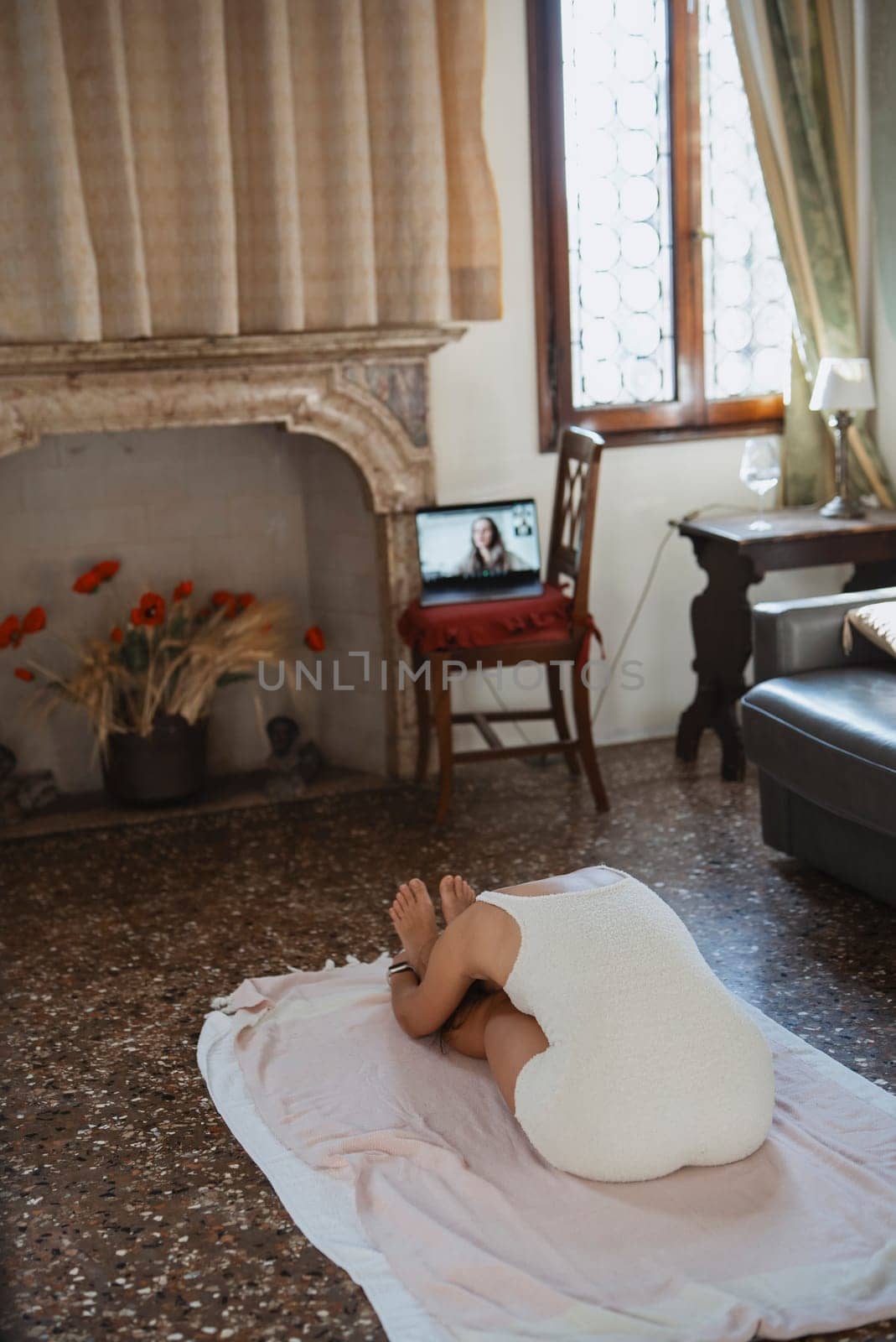 A serene and peaceful indoor scene featuring a person comfortably relaxed at home while using a laptop