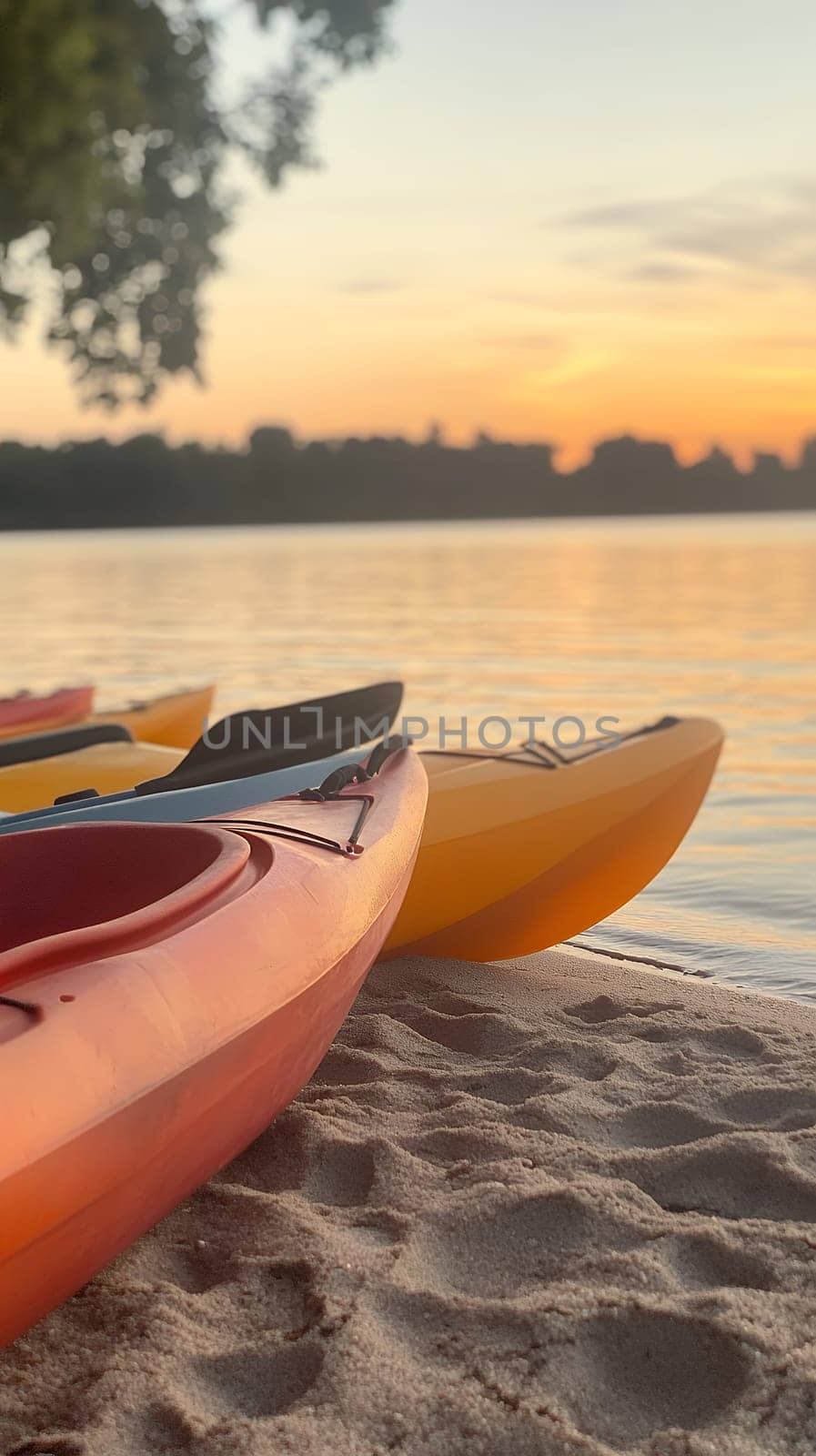 Vibrant kayaks rest on a sandy shore as the sun sets, casting a warm glow over the tranquil waters.