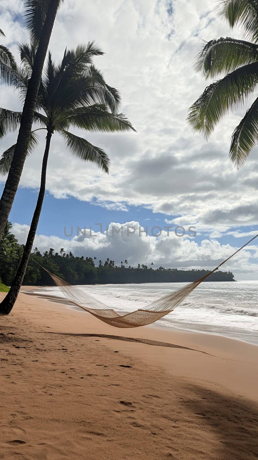 A tranquil hammock sways gently between palm trees on a secluded beach, perfect for relaxation.