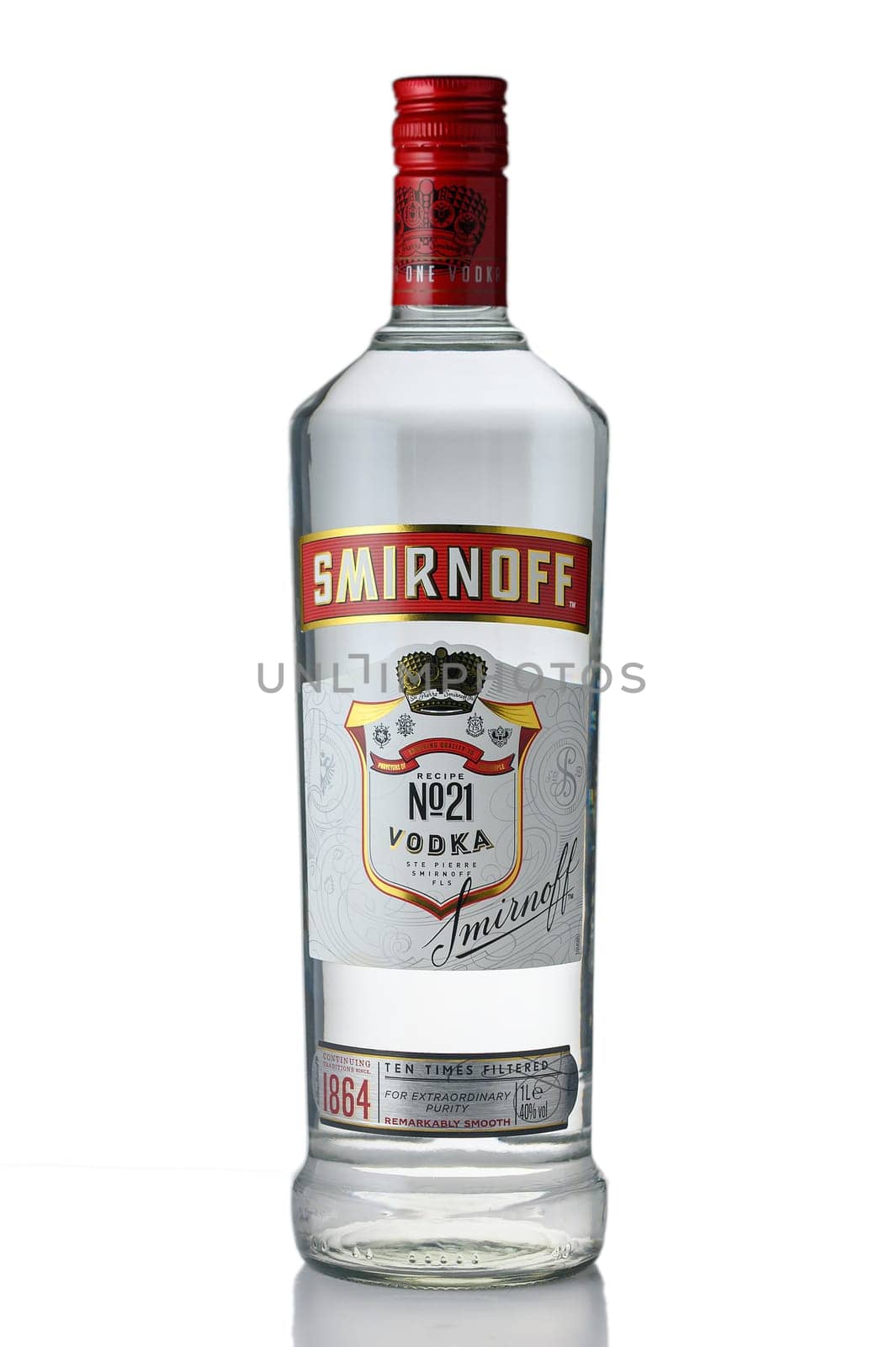 Gaziveren Cyprus -04.04.2025 Crafted for sophistication, a transparent Smirnoff vodka bottle sits elegantly against a simple backdrop. The bright red cap adds a vibrant touch, perfect for gatherings or special occasions.