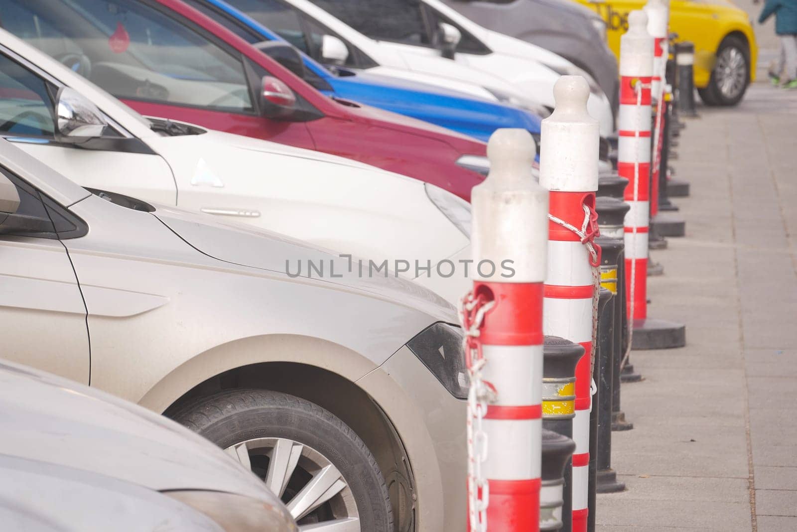 Multiple vehicles are well-organized in a parking area during daytime.