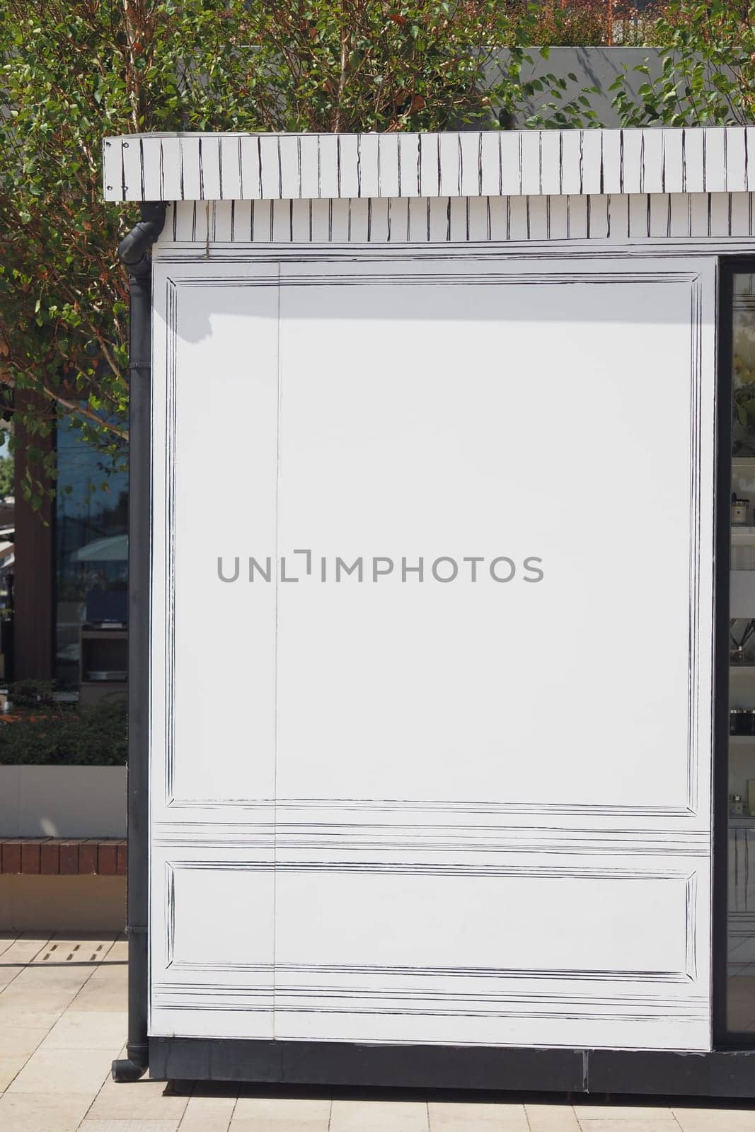 A blank advertising panel is located in a busy city environment.