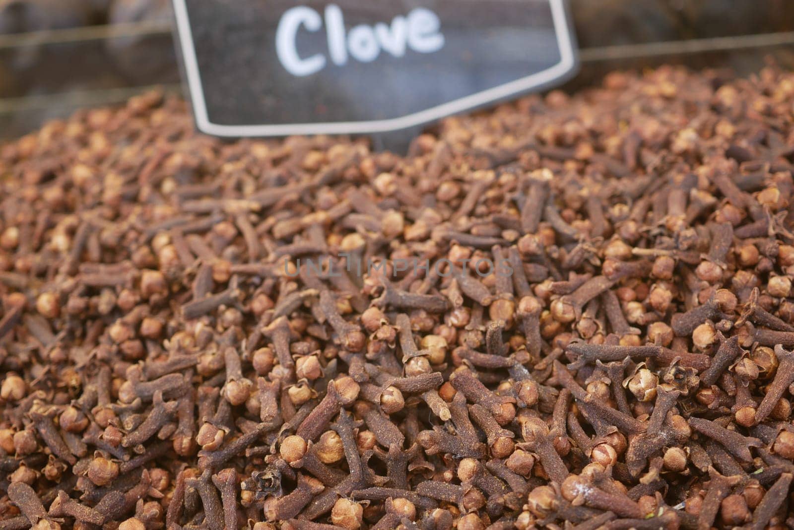 Clove spices are piled high at a marketplace, ready for purchase.
