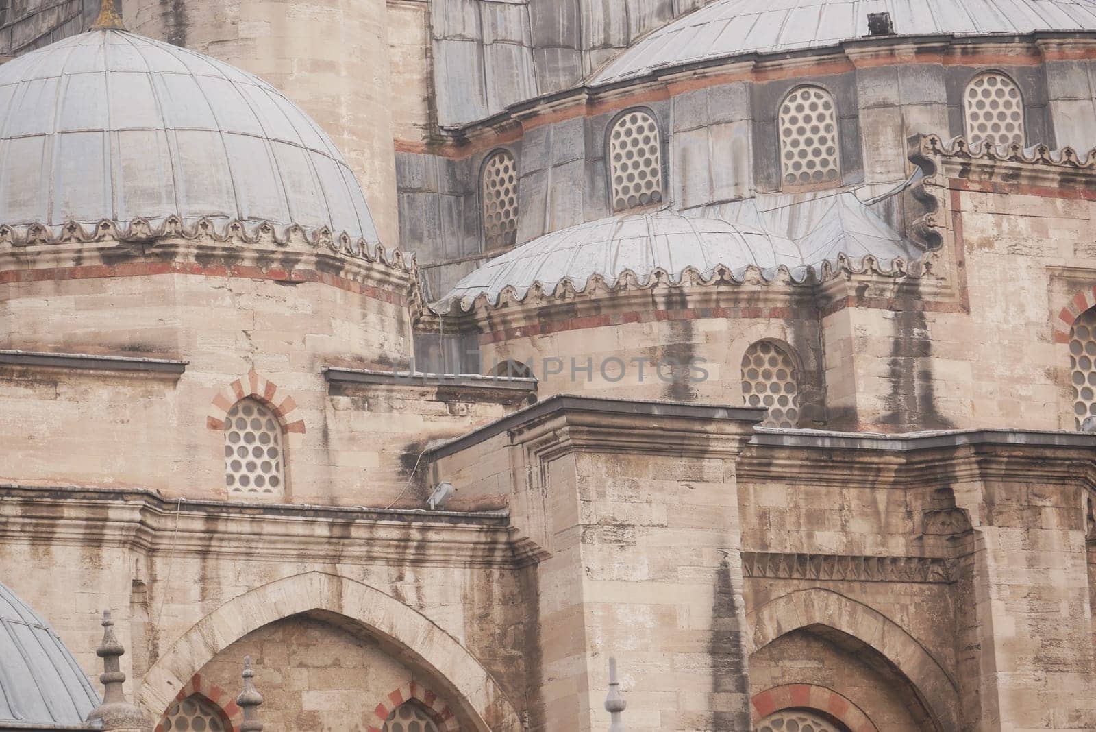 Intricate designs and domes of a historic mosque showcase craftsmanship.