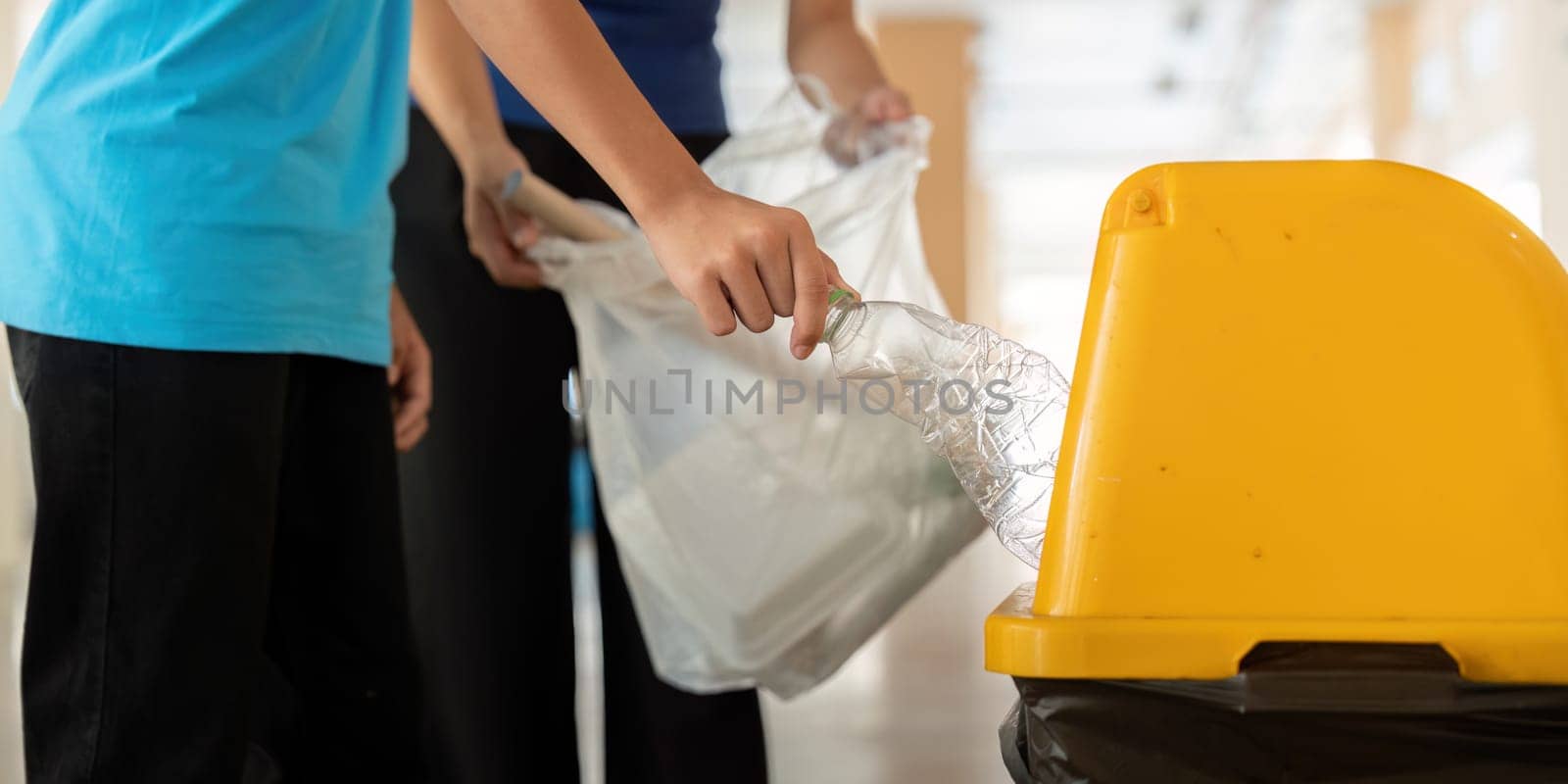 One individual shows proactive steps towards environmental conservation by properly disposing of plastic waste, promoting awareness about recycling and sustainability.