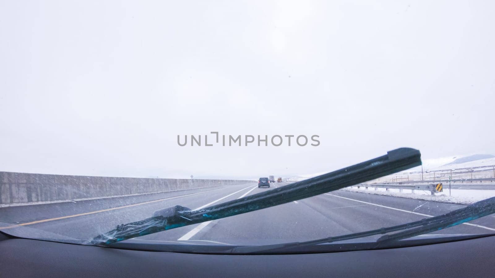 Denver, Colorado, USA-January 26, 2024-The open highway invites a peaceful drive, with snow-clad pines lining I-25 as the journey continues from Denver towards Colorado Springs on a snowy day.