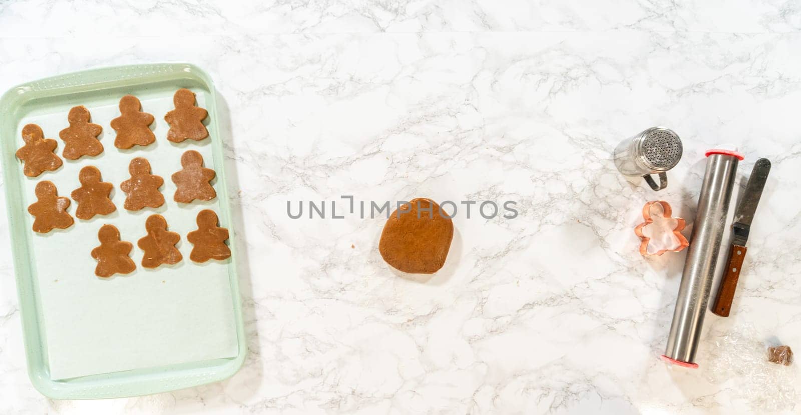 A smooth ball of gingerbread dough resting on a marble surface, ready to be rolled and cut with a gingerbread girl cookie cutter for Orange Zest Gingerbread Cookies.