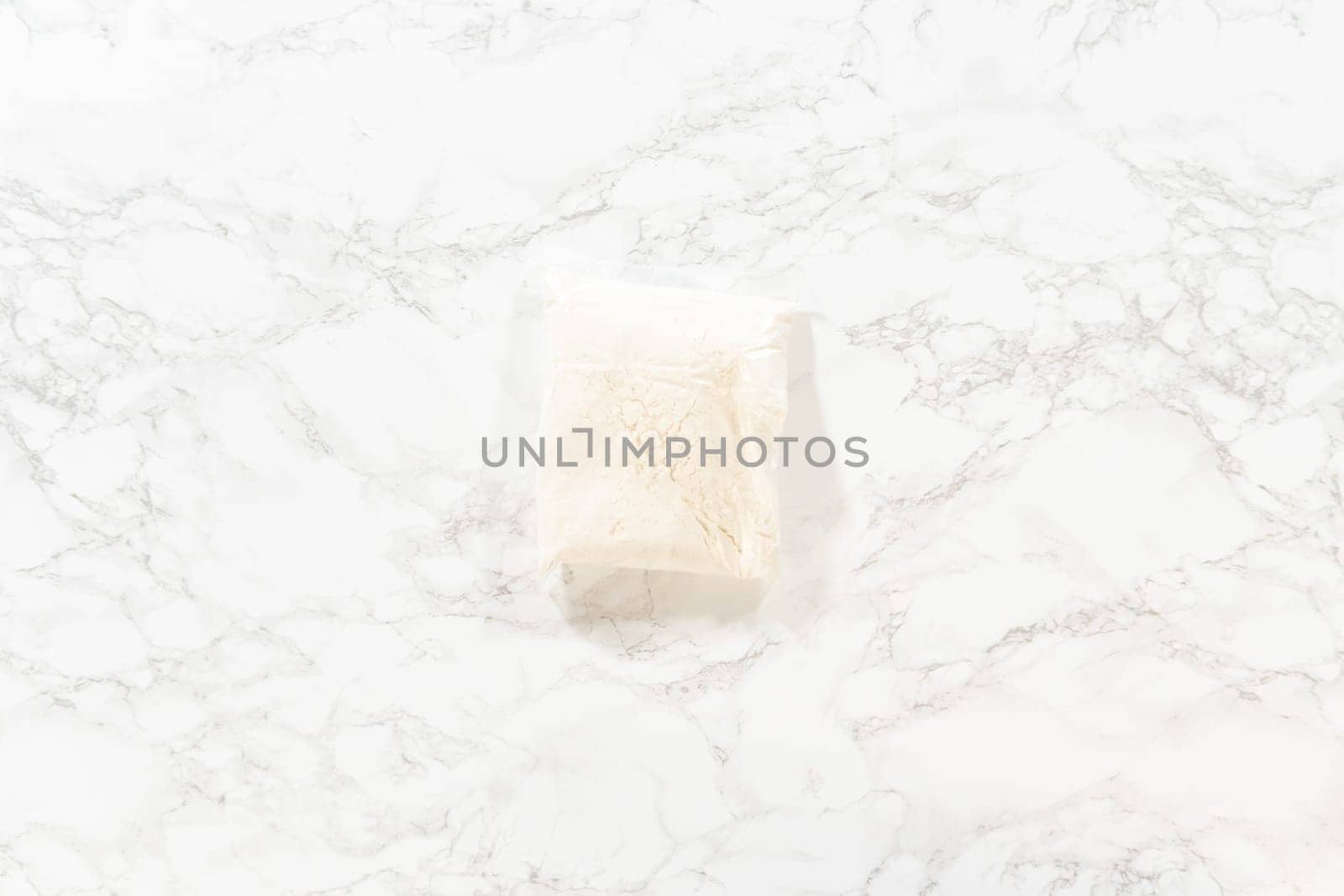 Flat lay. In a cozy kitchen, ingredients are meticulously measured in glass mixing bowls on the kitchen counter, all set to create a delightful homemade pumpkin bundt cake from cake mix.
