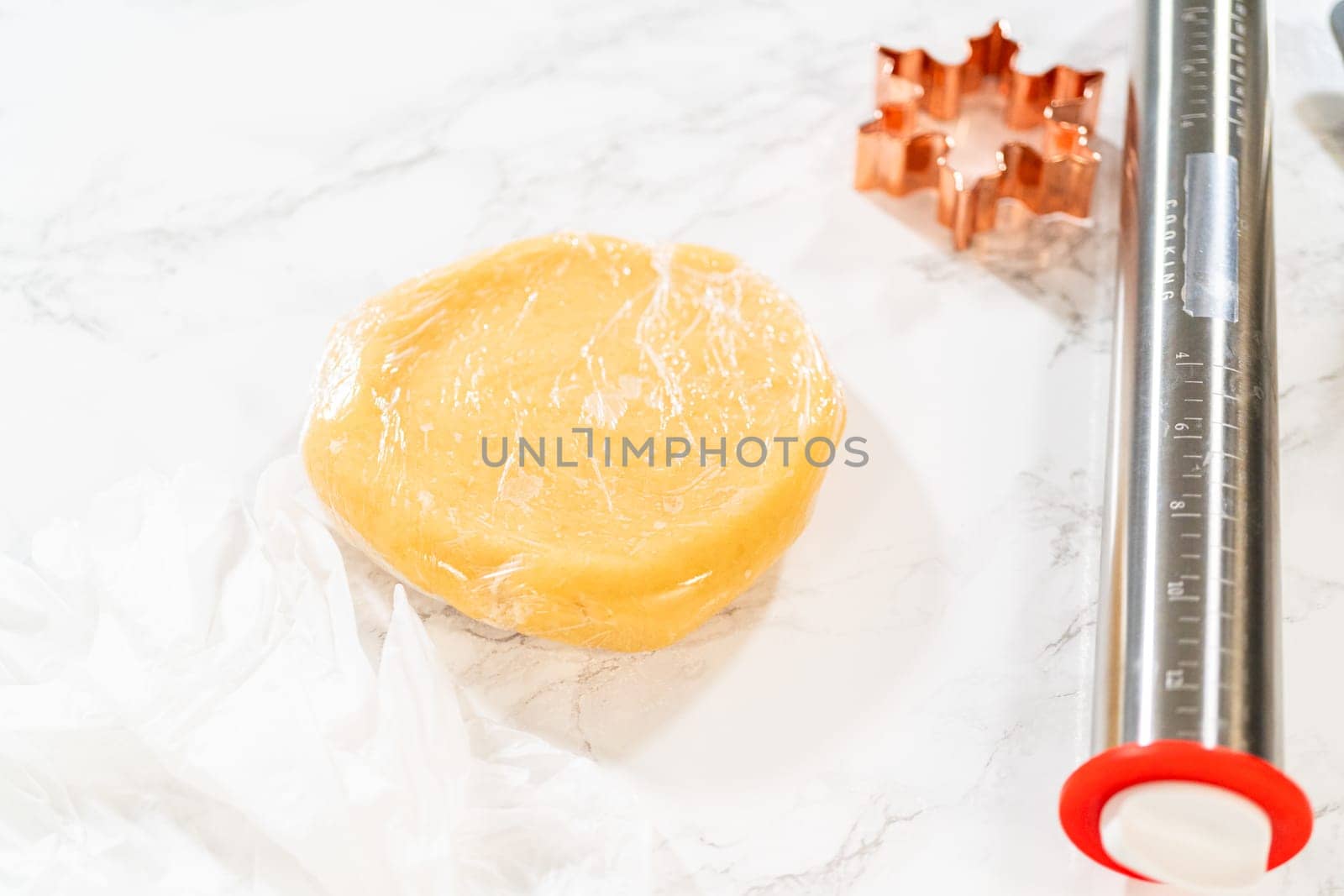 Sugar cookie dough wrapped in plastic wrap, ready for chilling before rolling and cutting