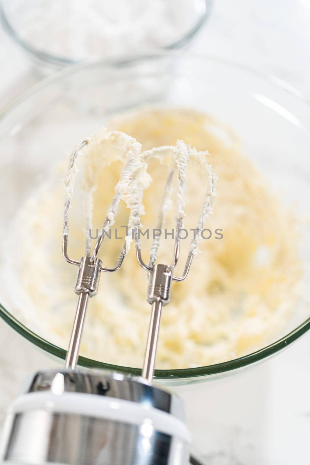 Preparing cream cheese frosting to ice the delicious pumpkin bundt cake.