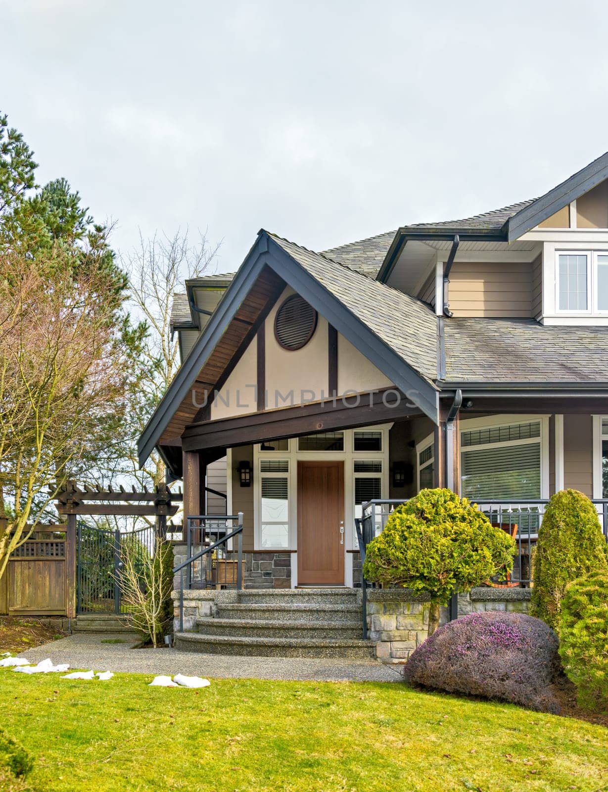 A perfect neighborhood. Nicely landscaped front yard of luxury residential house with paved pathway to the entrance. Luxury residential house for sale