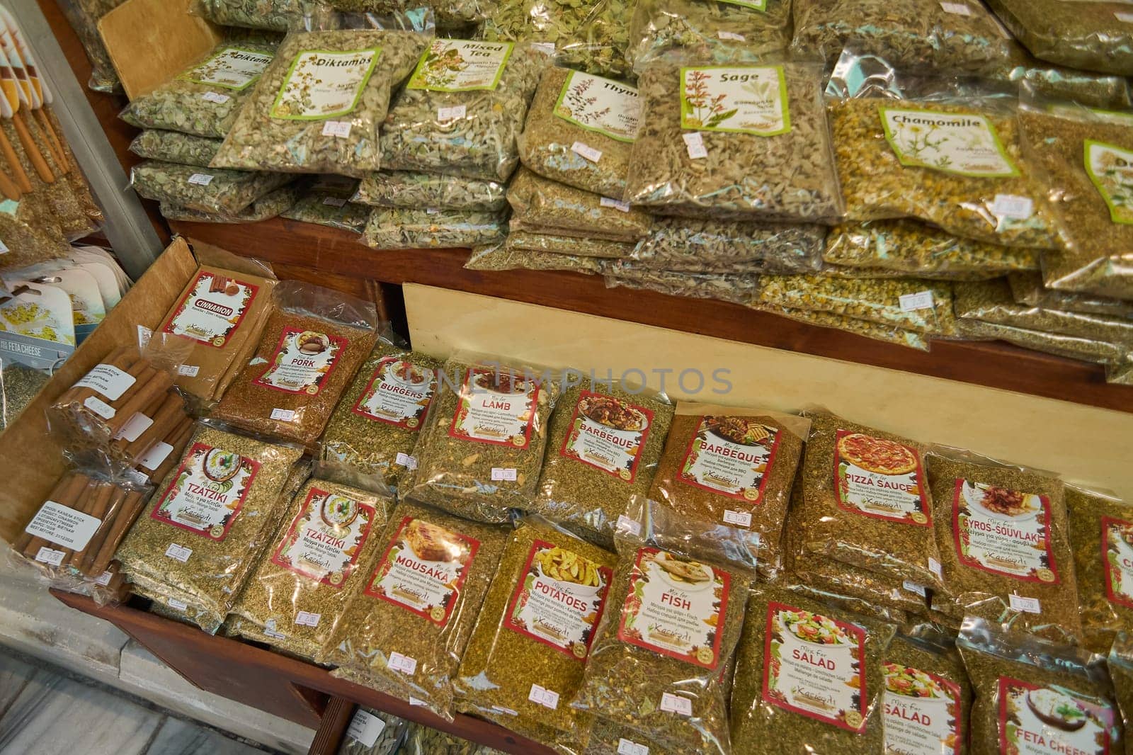 Crete, Greece - April 5, 2025: Vibrant spice shop showcasing cooking essentials like barbecue seasoning, pizza sauce herbs, and curry blends in clearly labeled and neatly stacked packaging.