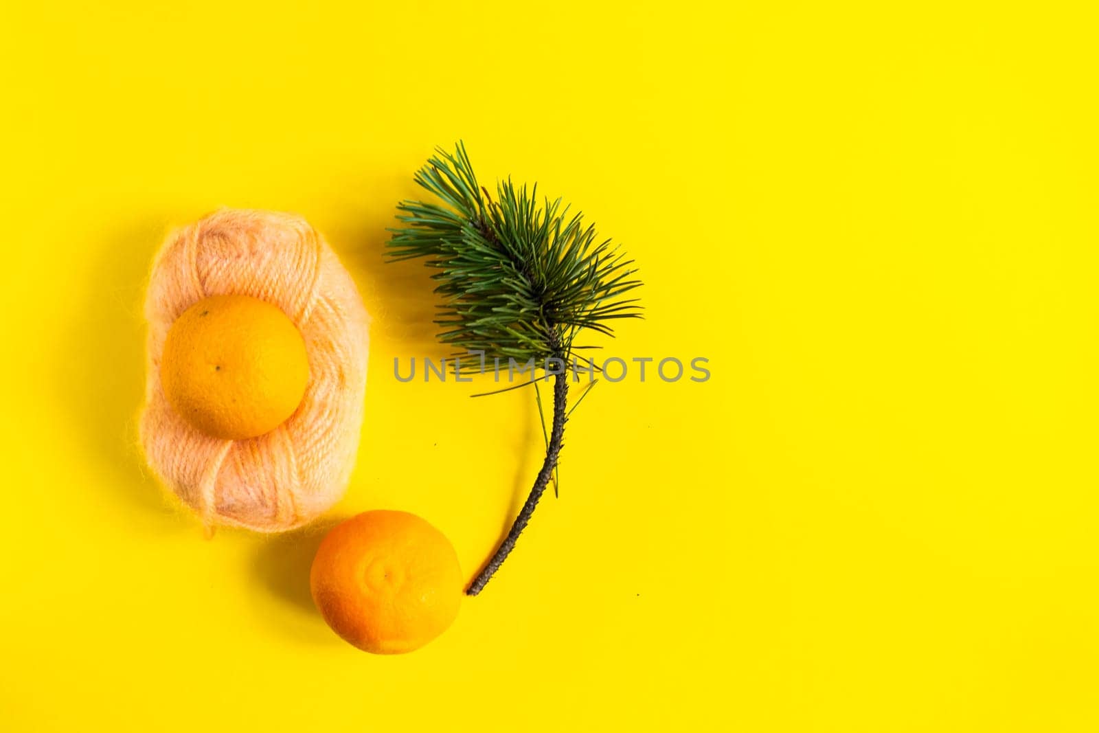 Christmas background with a fir tree branches and tangerines. Merry Christmas and Happy New Year