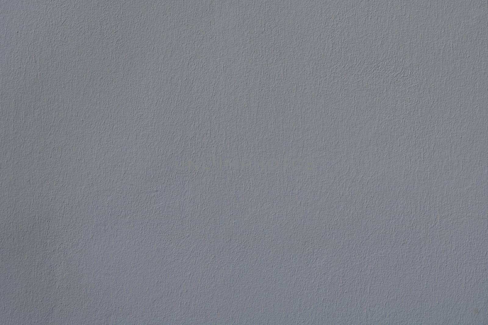 The soft gray wall, bathed in gentle natural light, creates a tranquil backdrop, encouraging moments of reflection and artistic expression in a peaceful space.