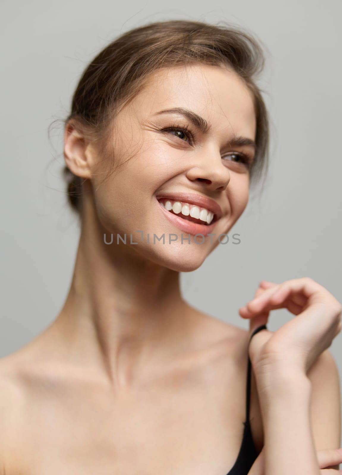 Cheerful female posing with a beaming smile and sparkling eyes, exuding confidence and warmth. Ideal for beauty, wellness, and lifestyle themes.