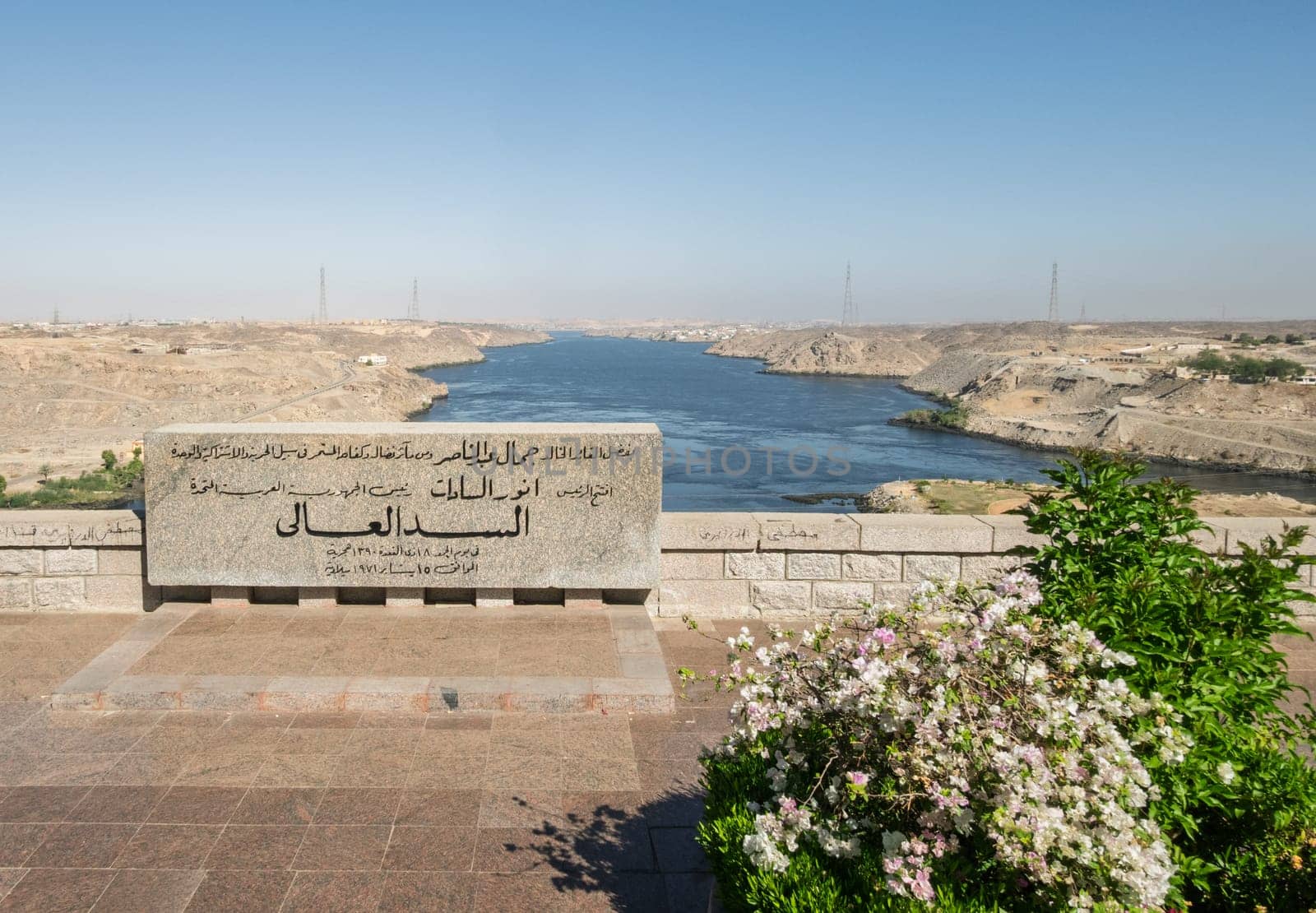 Aswan, Egypt - 4 November 2024: View down the sloping side of the Aswan Dam in Egypt at the river Nile with commemorative stone