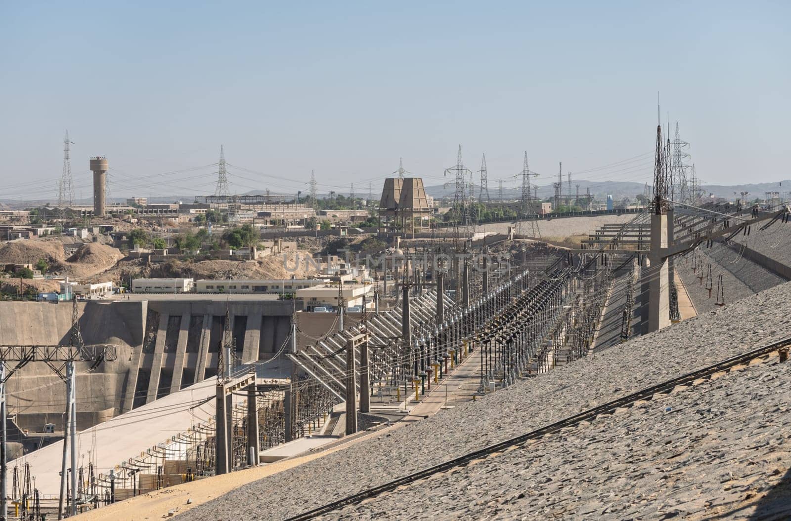 View down the sloping side of the Aswan Dam in Egypt to the power plant generating electricity from the water flow