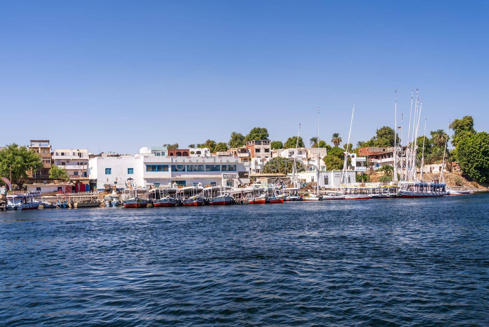 Bars and restaurants line the shores of Nile with ferry boats and cruise boats docked alongside