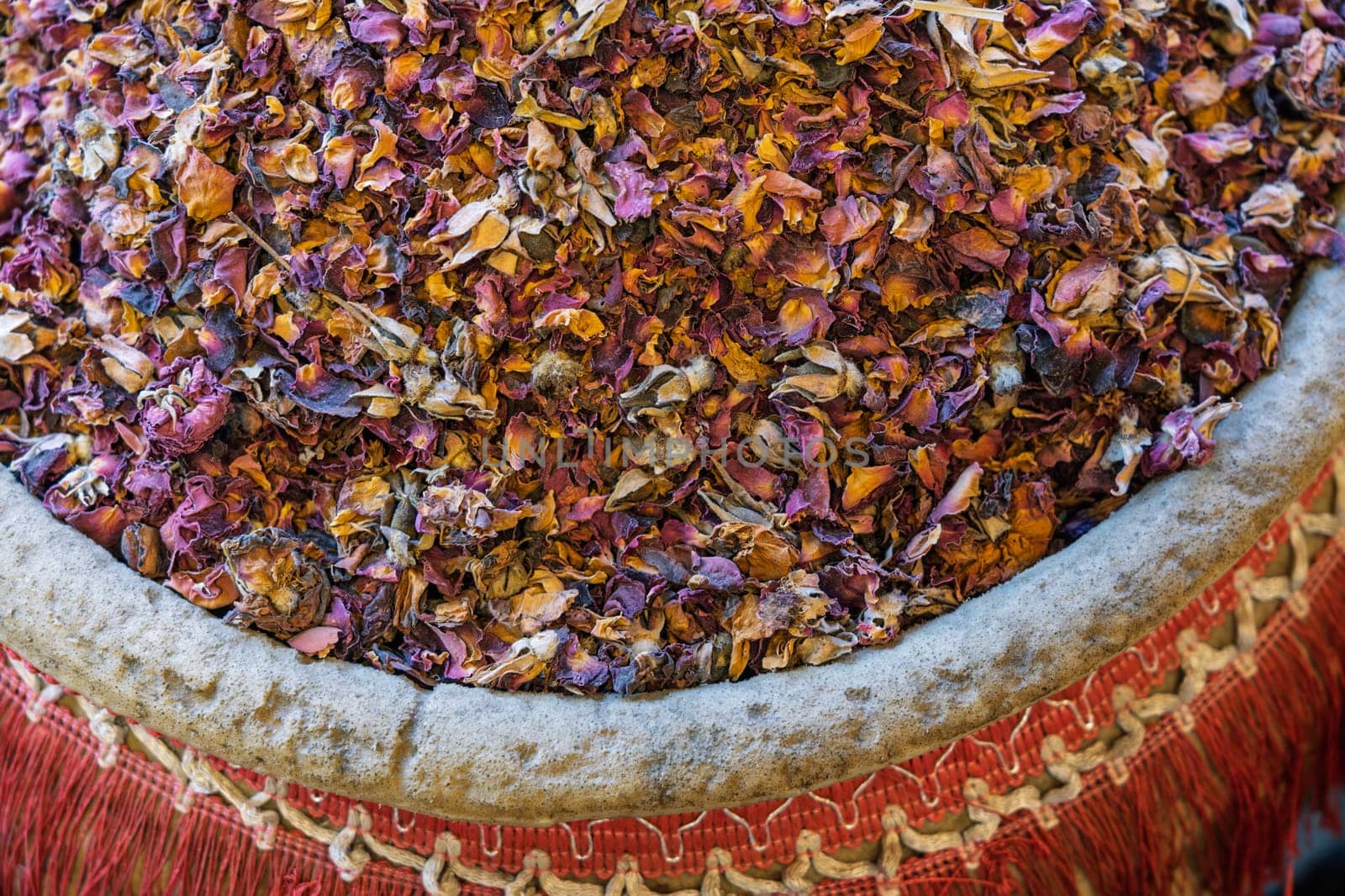 Dried rose leaves in large jar in a spice market in Aswan Egypt