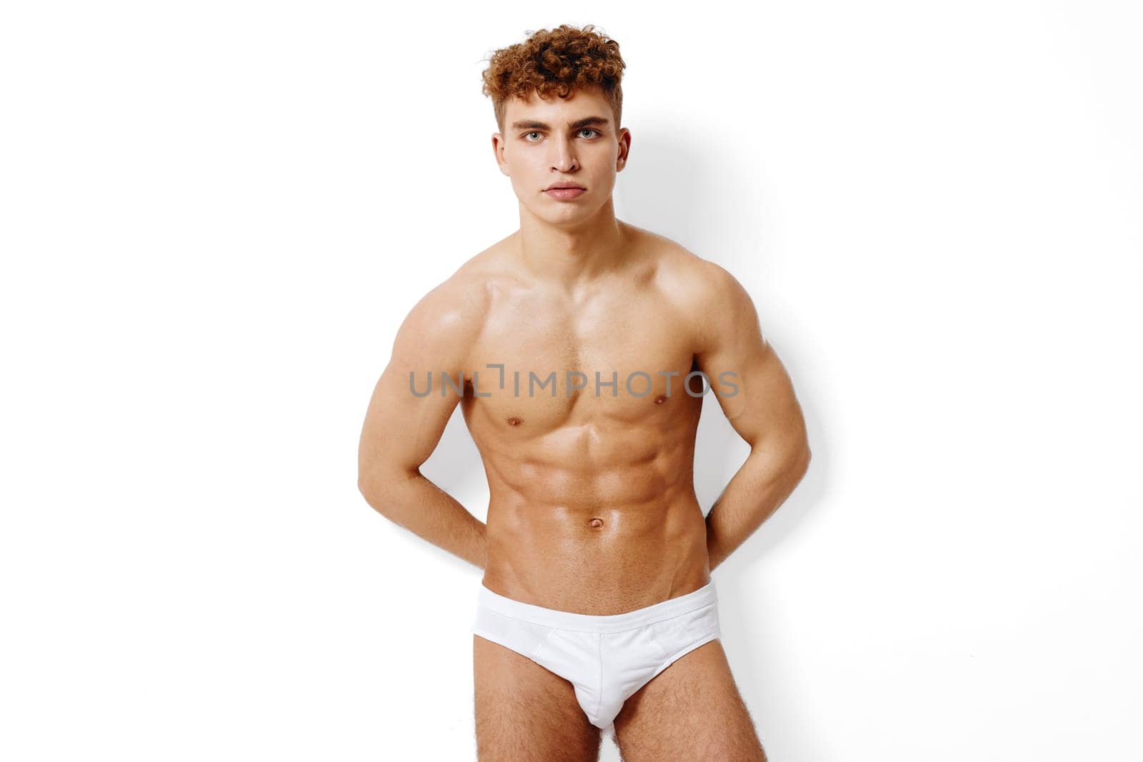 Muscular young male model showcasing confidence in trendy underwear, embodying fitness and fashion aesthetics.