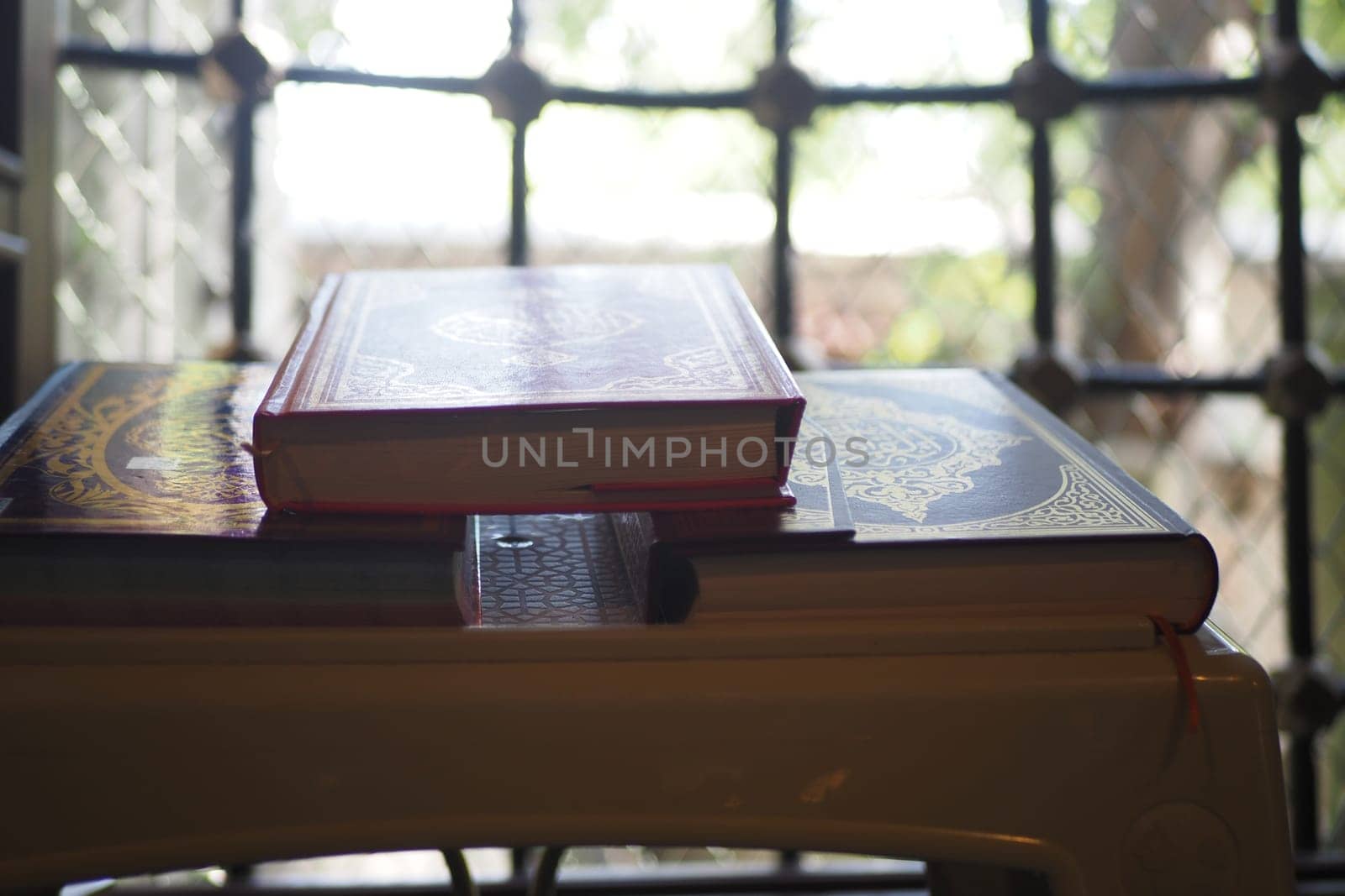 quran resting on a small table in a mosque .