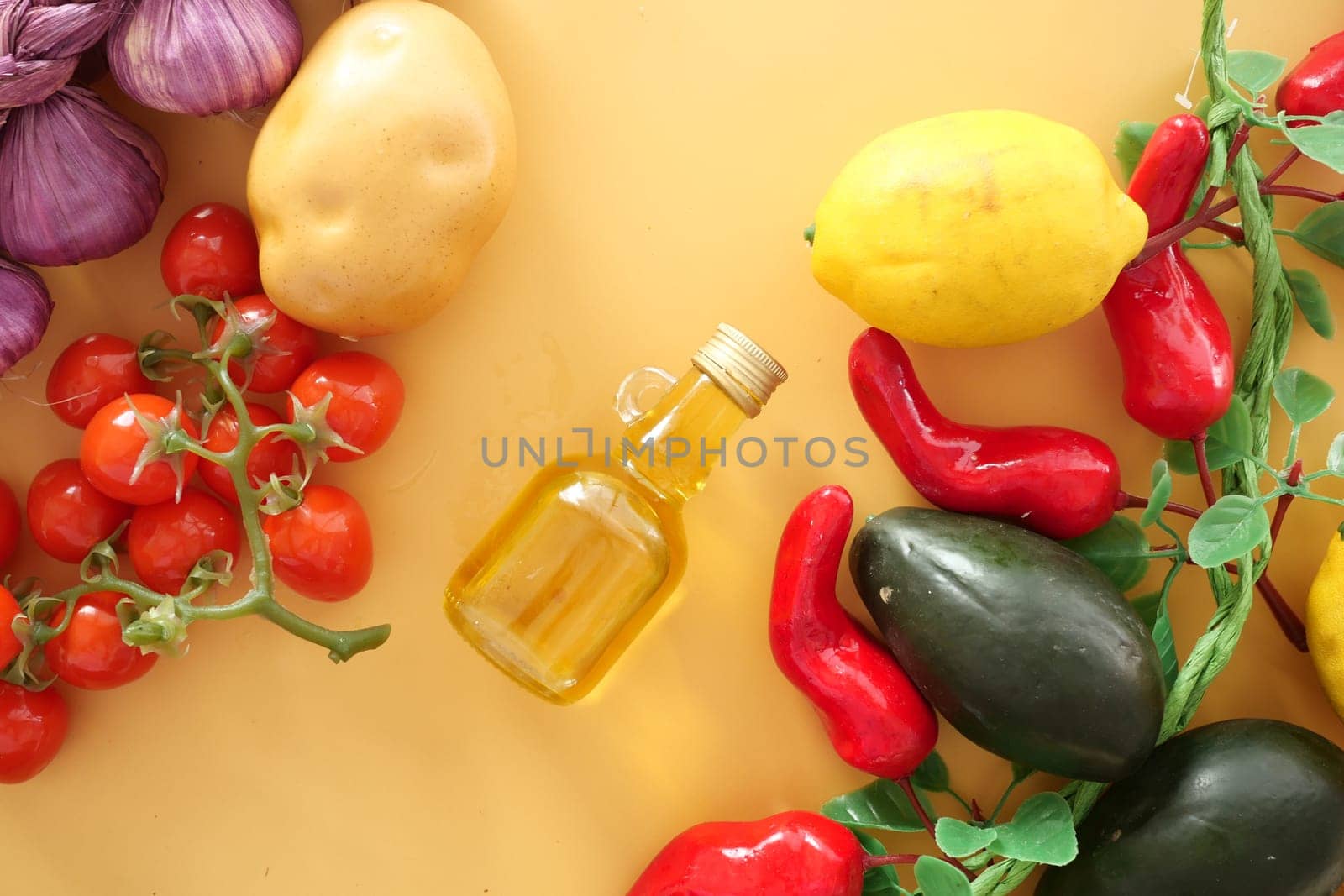 Colorful vegetables, including tomatoes, peppers, and lemon, displayed with oil.