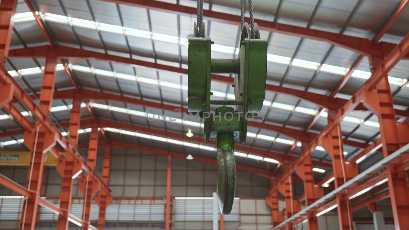 Closeup of swivel chain hook crane of electric hoist in factory workshop, pullersSwivel chain hook equipment for pullers, industry lifting machine