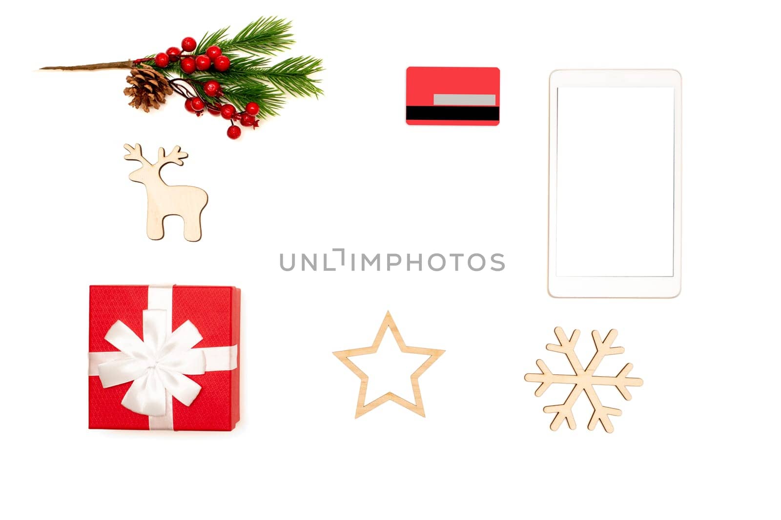 Frame made of digital tablet, credit card, gift box and christmas toys on white background top view. Online shopping concept in christmas. Mock up. Copy space