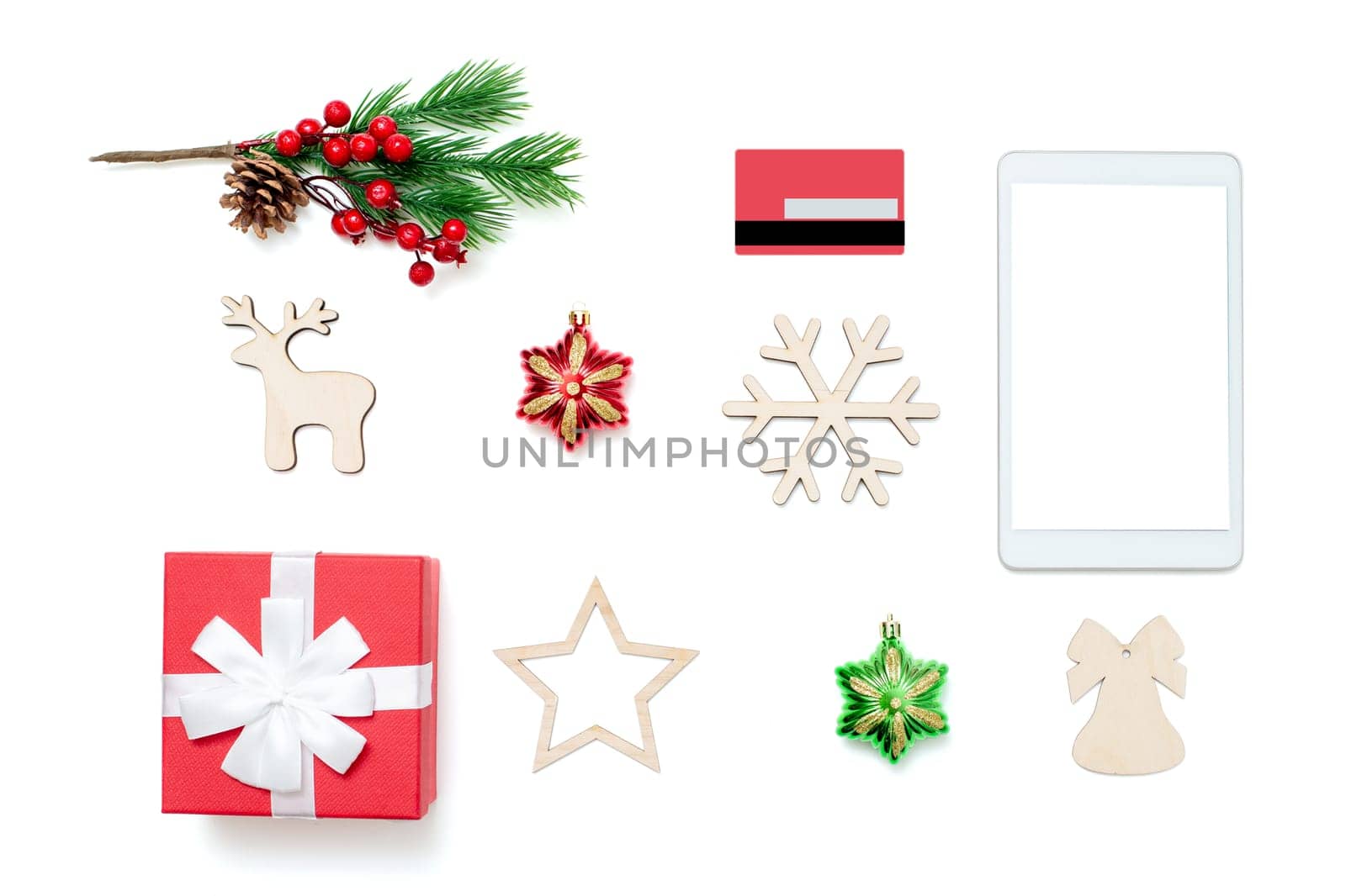 Tablet screen with copy space on top of white table, credit card, gift box and Christmas toys. Online shopping concept in christmas. Mock up. Copy space
