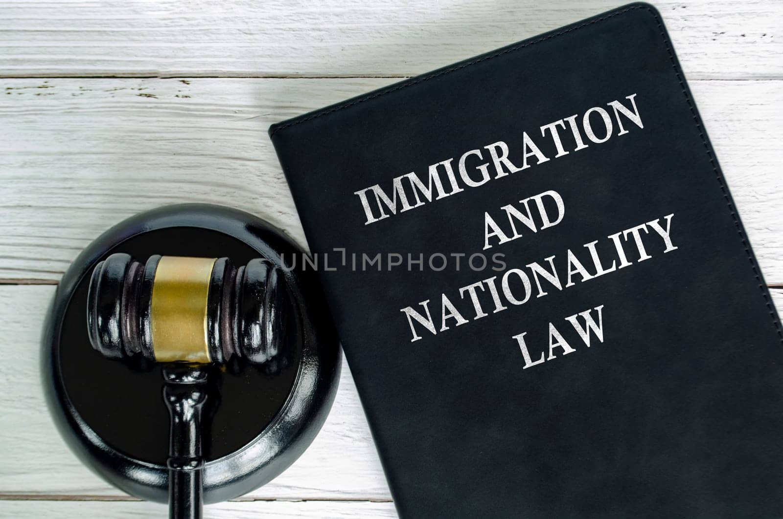 Top view of Immigration and Nationality Law book with gavel background.