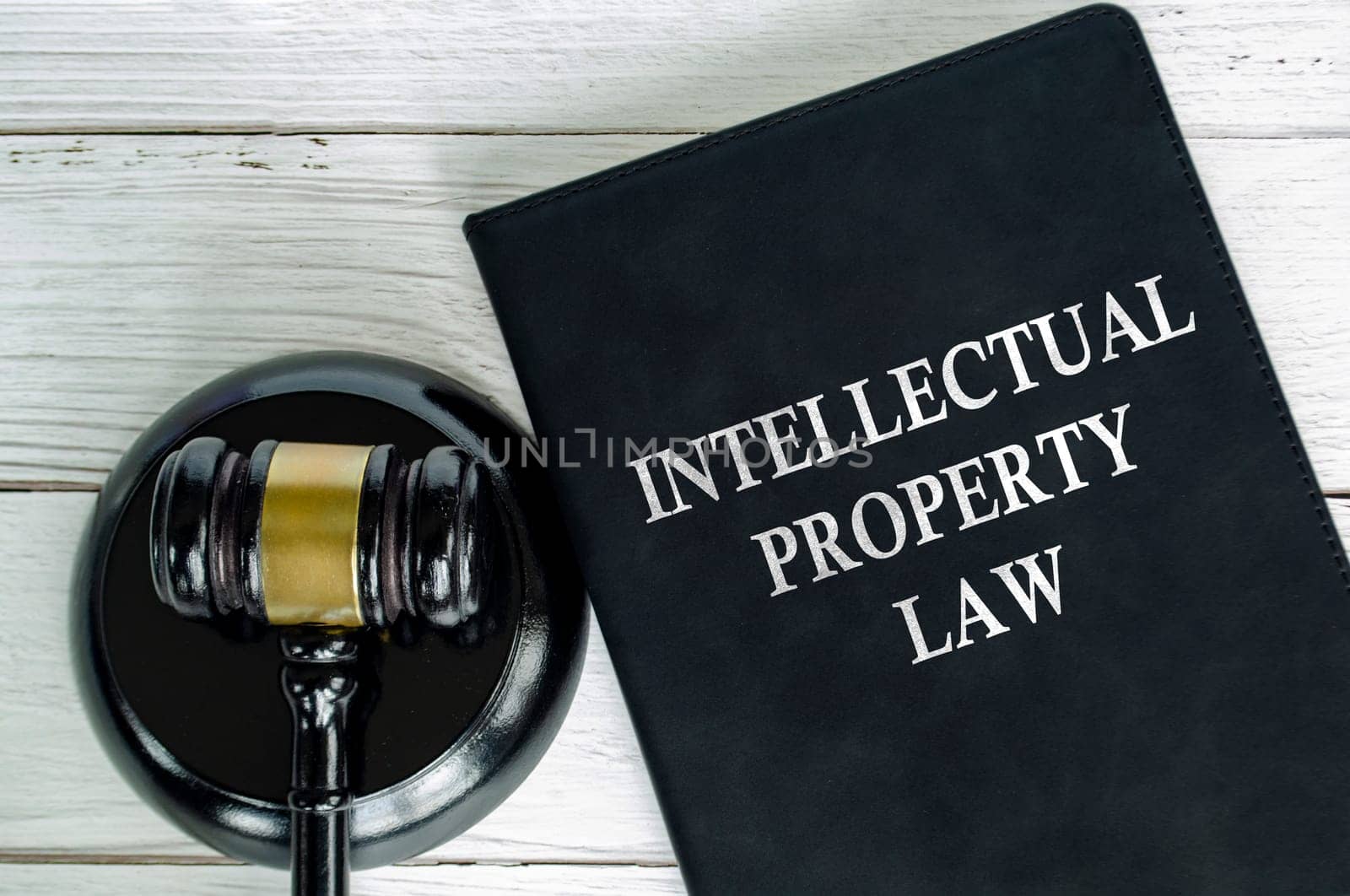 Top view of Intellectual Property Law book with gavel background.