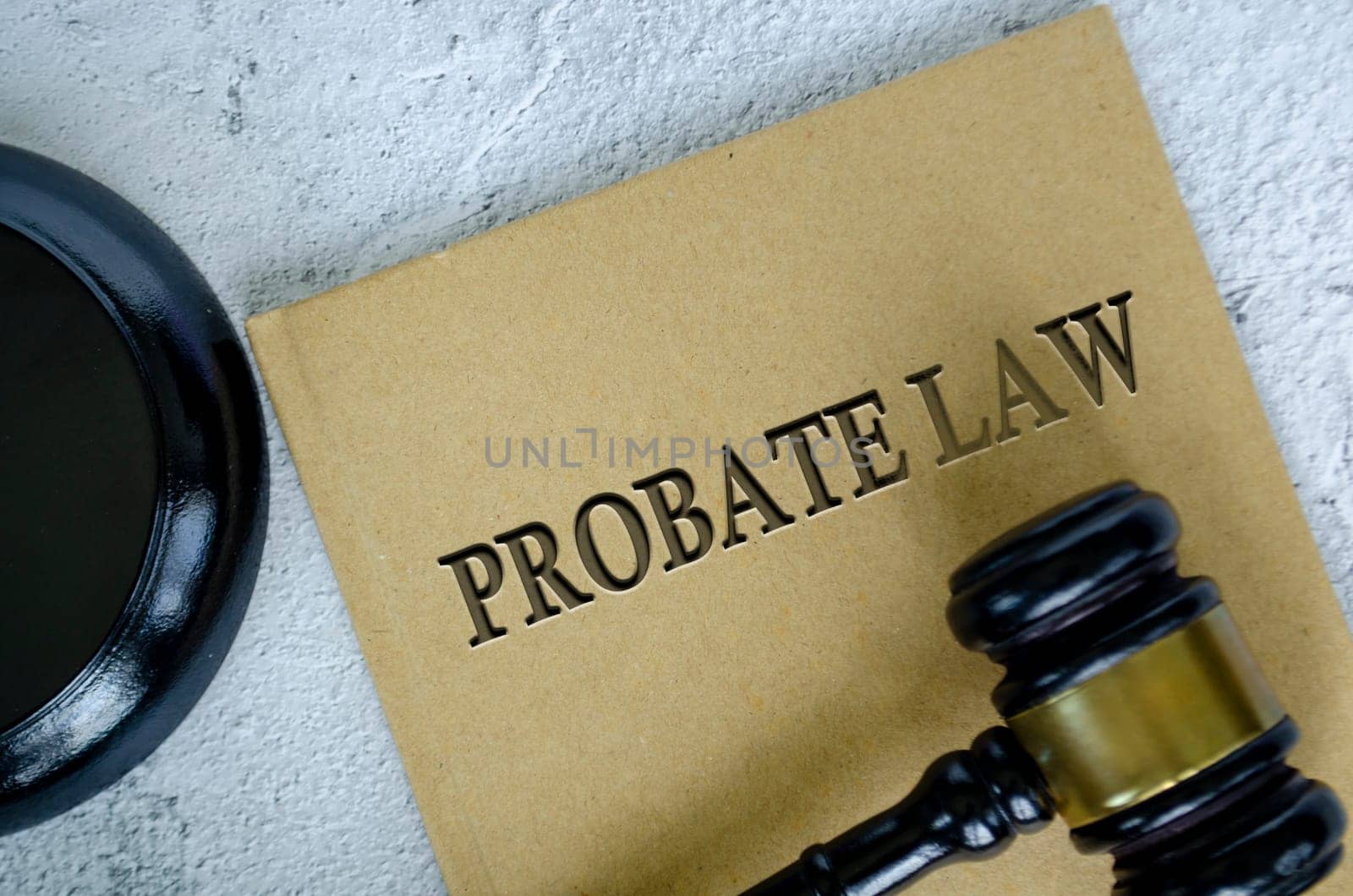 Top view of Probate Law book with gavel on marble background.